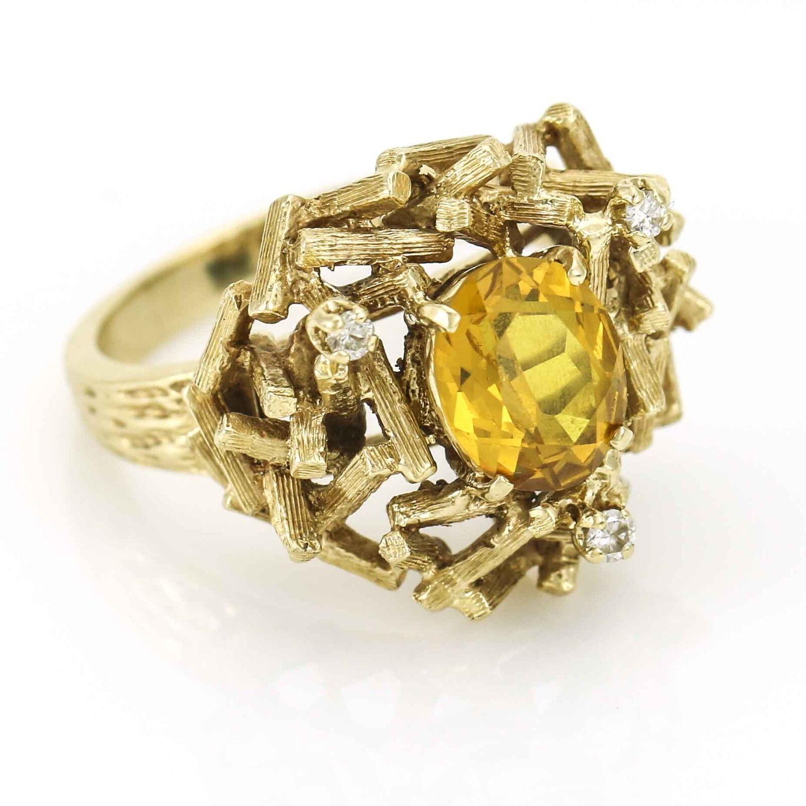 Vintage Brutalist ring with oval Citrine and 3 diamond accents crafted of 14 karat yellow gold. Circa 1970s. Size 9.5. Citrine, 9.5mm x 8mm. Weight, 10.7 grams.

Previously owned, in excellent condition with expected wear. Comes with gift box.
