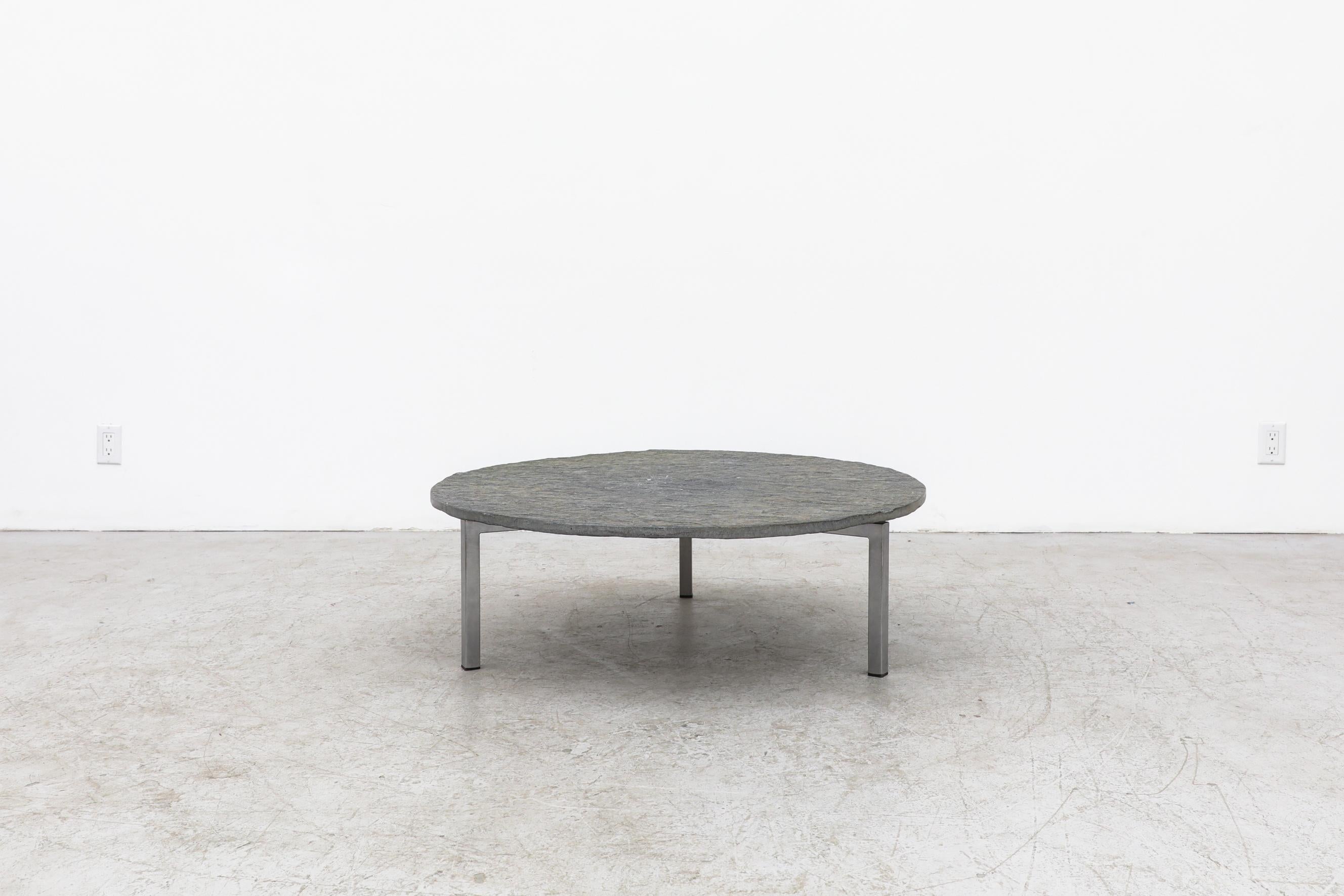 1970's, Stunning brutalist stone side or coffee table with a flat chrome tripod base. The top has a small hole through the center of it. There are bolts in the frame top which act as leveling tools. In original condition with visible patina and