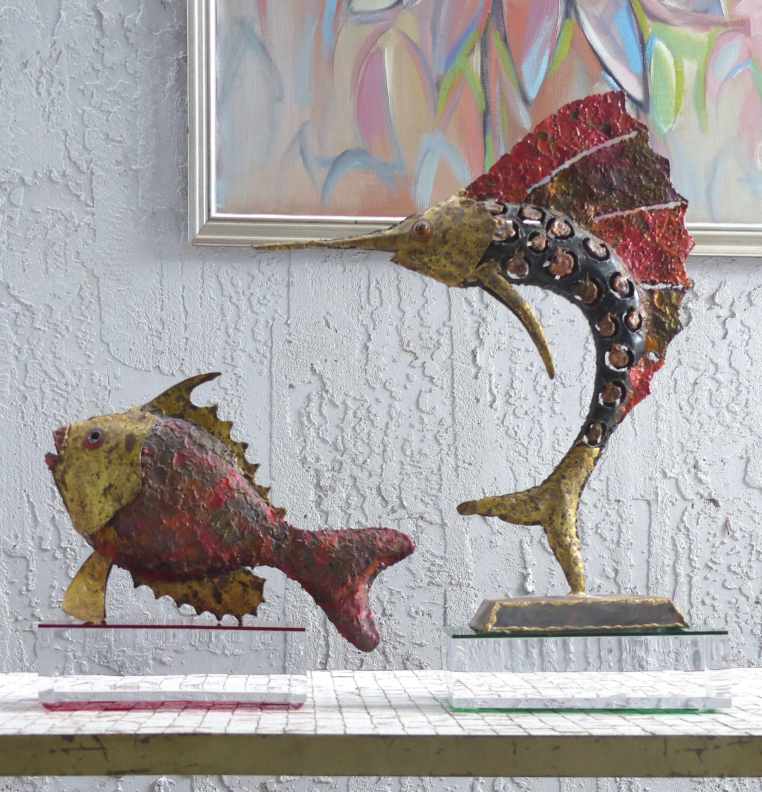 1970s Brutalist Torch-Cut Brass Sailfish and Fish Sculptures

Offered for sale is a set of two circa 1970s torched metal Brutalist sculptures of fish with great patinated coloring and textures. The sailfish is dancing on his tail supported upon a