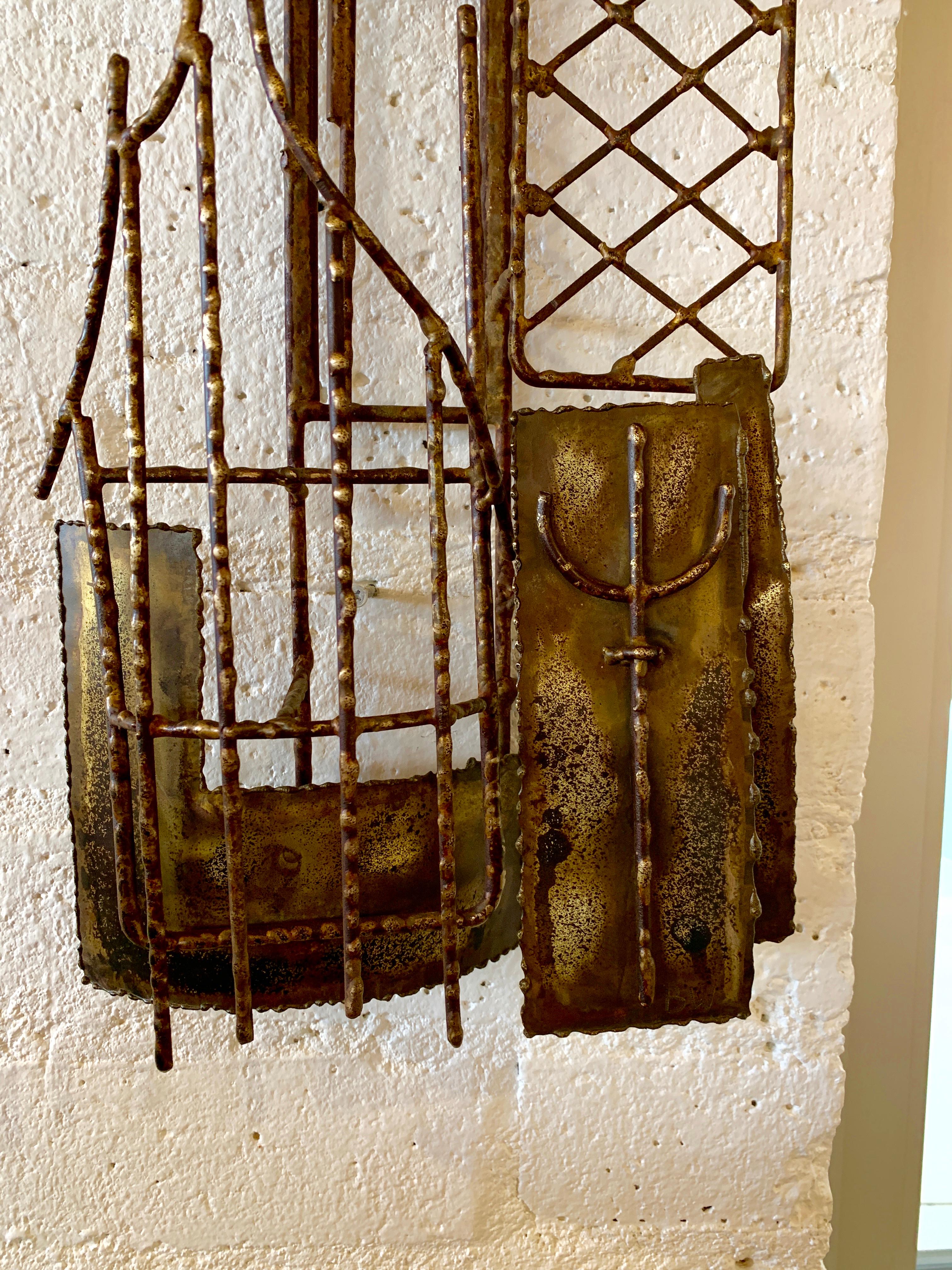 A vintage brutalist wall sculpture in iron and brass. Monogrammed BW on the front bottom right. The sculpture has been cleaned up and re-lacquered. It still has age appropriate wear and imperfections.