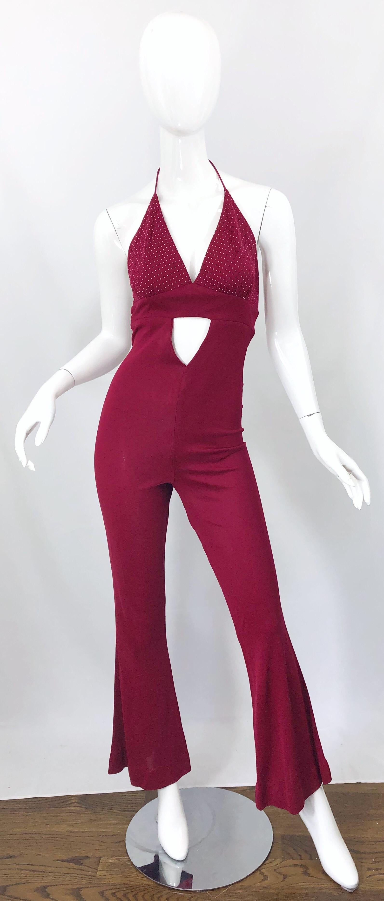 Amazing 1970s Fredericks of Hollywood burgundy / maroon one piece jersey cut-out disco jumpsuit! Features tiny white polka dots on the halter bodice. Cut-out below the bust, and just above the stomach. Hidden zipper up the back. Ties at the back top