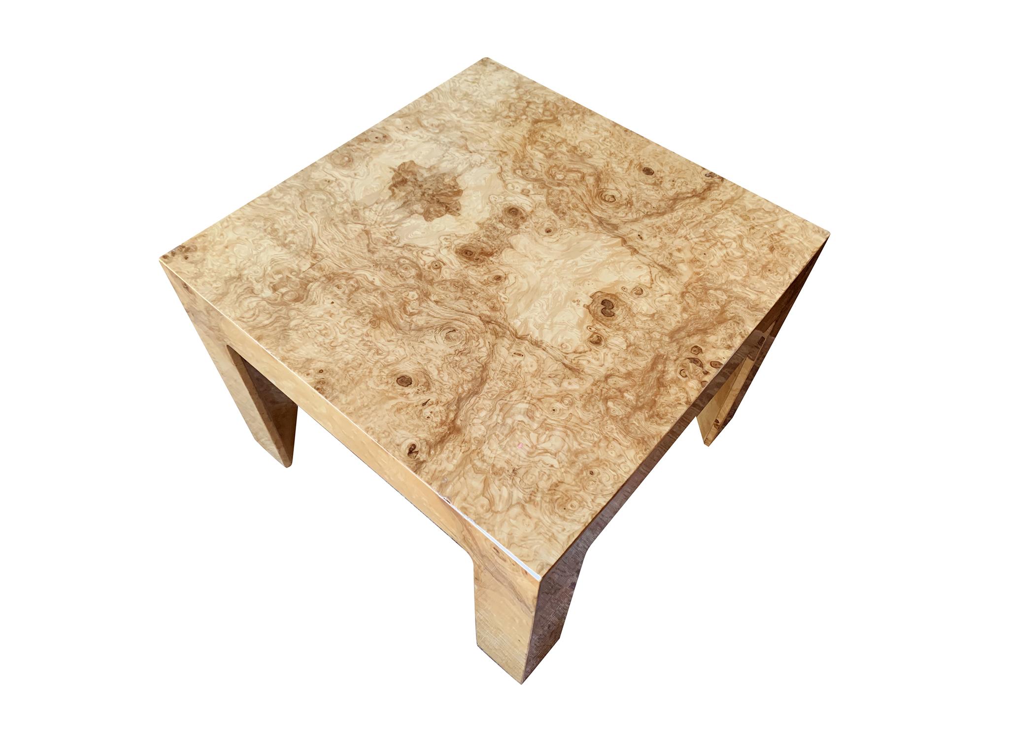 A 1970s square coffee or side table. It is comprised of burl wood with a warm honey-yellow hue and grain. This elegant table that marries simple, slick-lined form with a rich, eye-dazzling surface. Other noteworthy design qualities are the table's