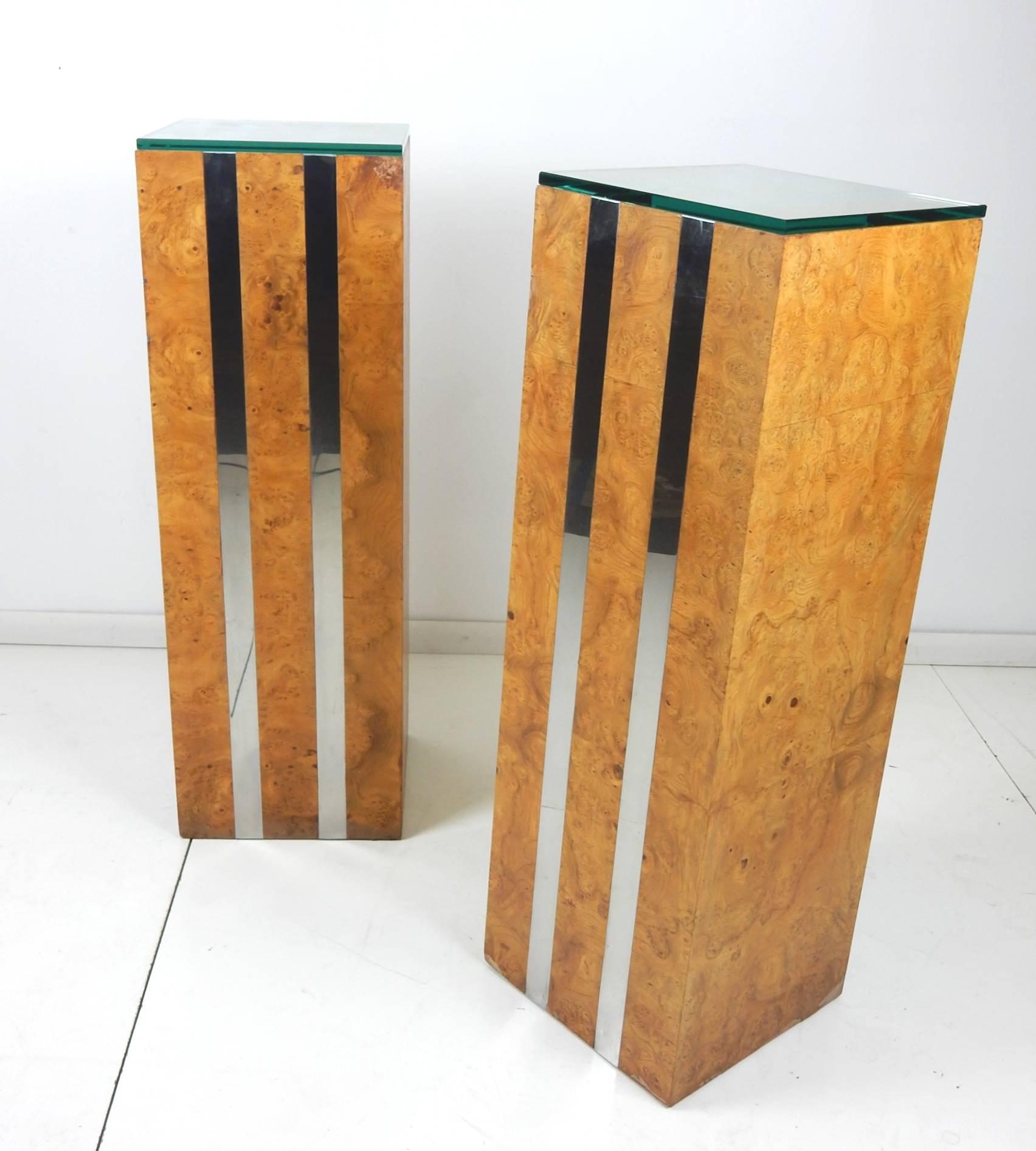 Pair of olive burl wood pedestals with banded chrome strips down sides and top. Measure: 1/2 thick green glass tops,
circa 1970s.