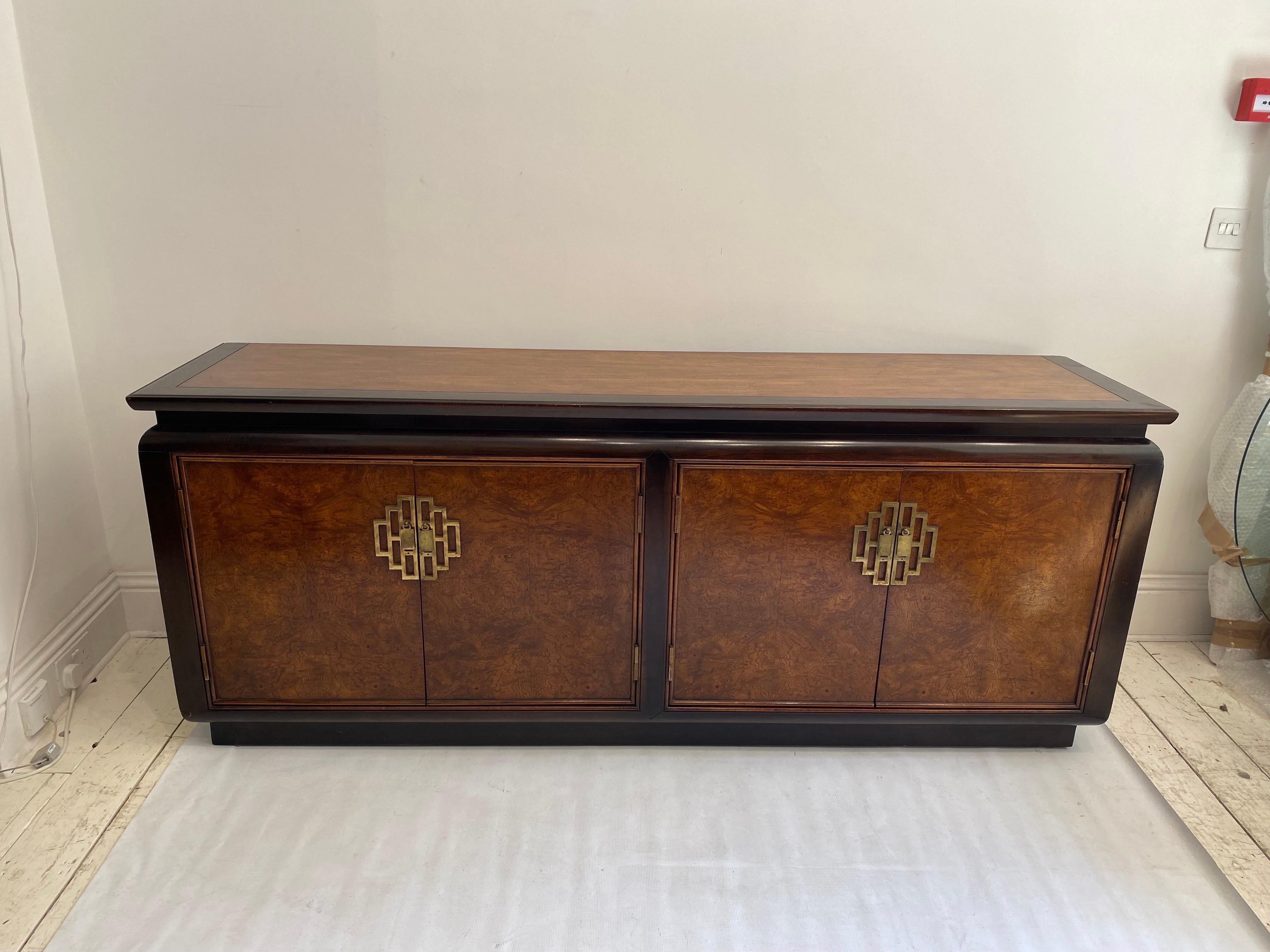 This sideboard, in burl and brass finish details by Raymond Sabota for Century Furniture Of Distinction from his Chin Hua Collection is a rare UK import. Although Century Furniture were popular in USA, in Europe and UK they are rarely seen.

The