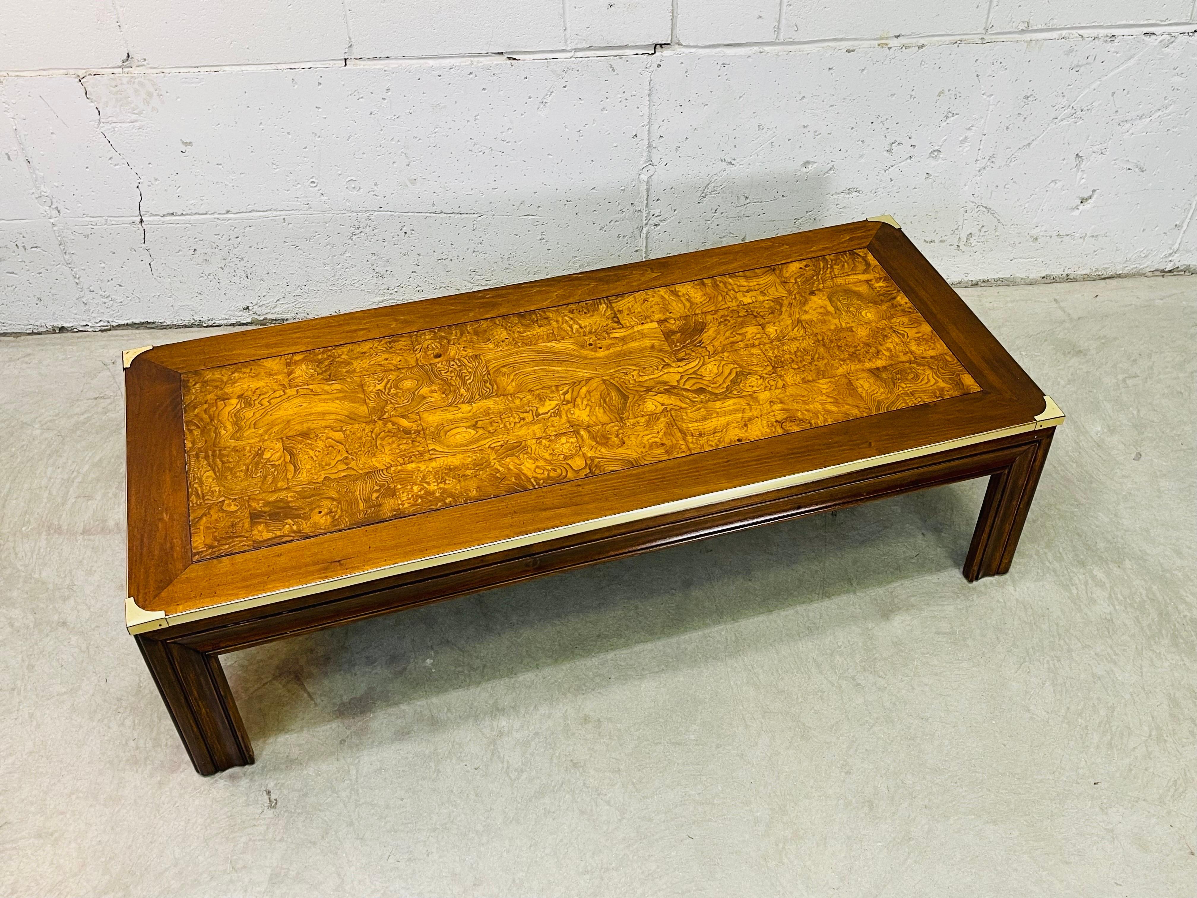 Vintage 1970s rectangular burlwood top coffee table with brass accented sides. Coffee table has large wood legs that make the table very sturdy. The burlwood is inset into the top of the table. No marks.
