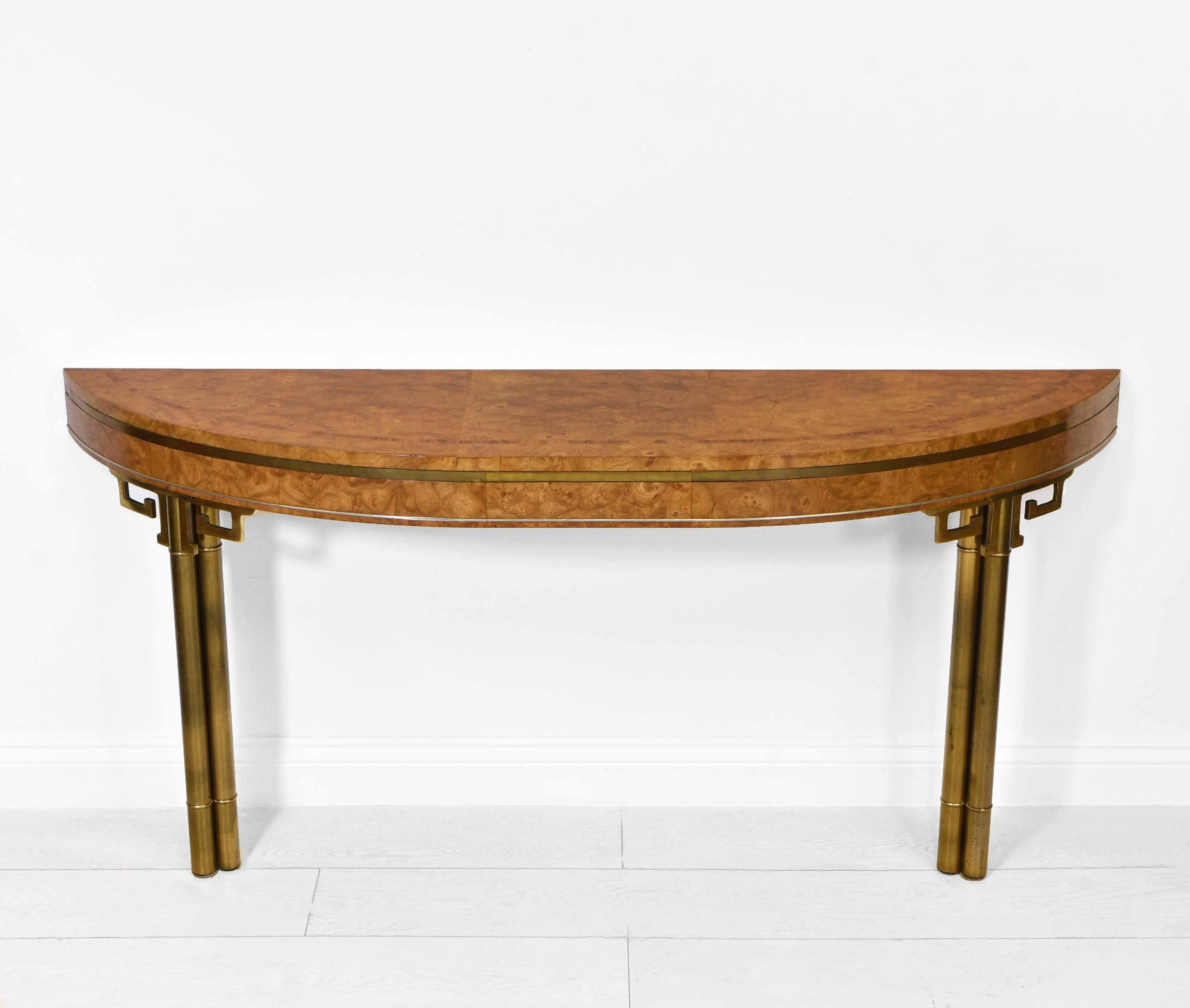 A wonderful vintage burr wood console table with brass Greek key detail. Circa 1970s. Almost certainly made by the American firm, Mastercraft, Grand Rapids, Michigan.

Superbly figured burr wood veneer to the top and frieze, which is a pale, golden