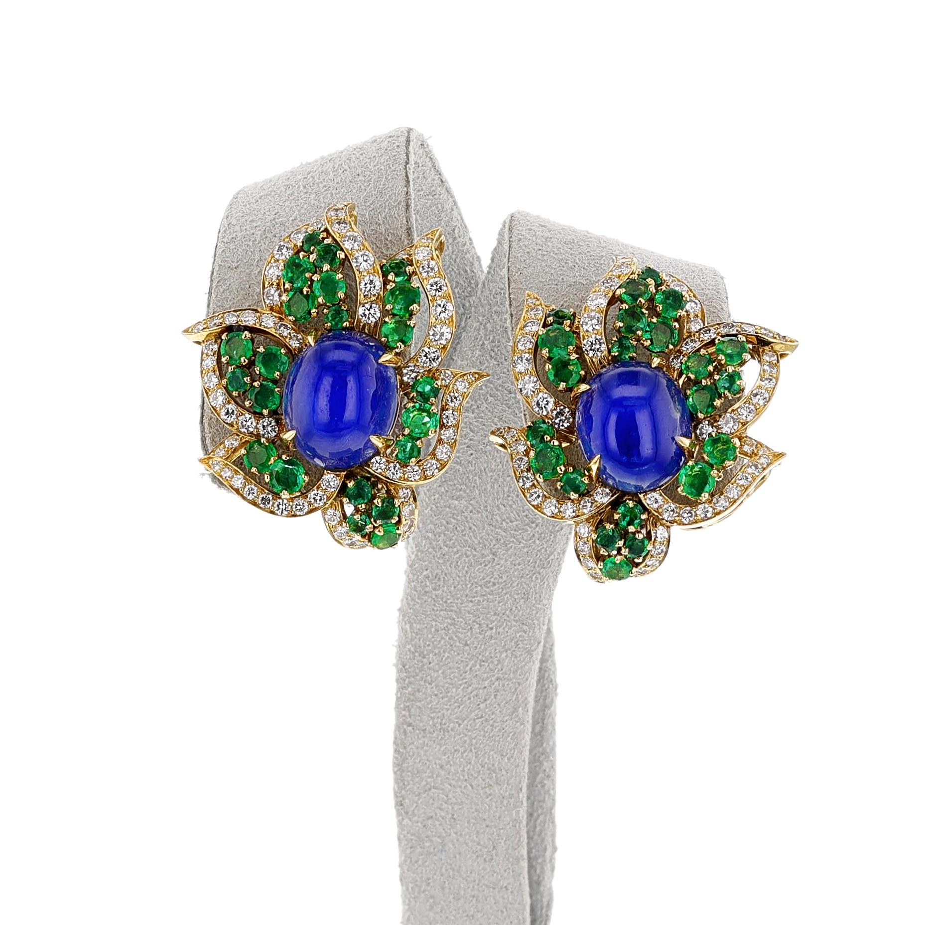 A pair of 1970s BVLGARI Sapphire Cabochon, Emerald and Diamond Earrings made in 18k. The sapphires weigh appx. 20 carats, and the emeralds weigh appx. 1.25 carats.  The dimensions are 1 1/8 x 1 1/8 inches. The GIA report states that that the