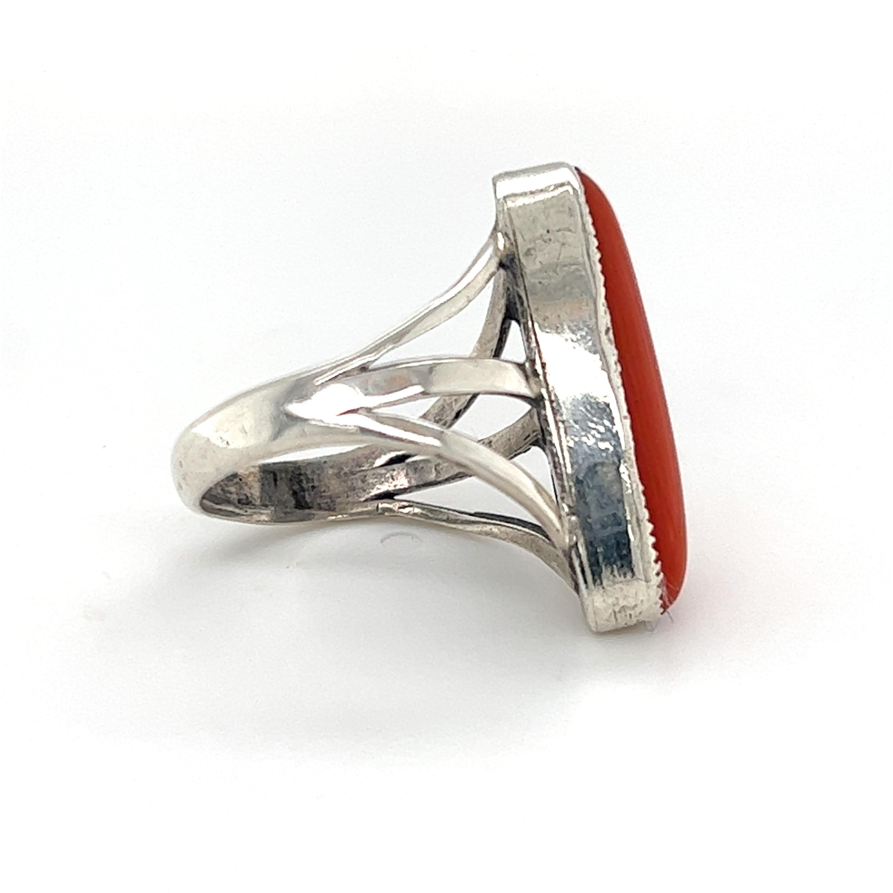 One sterling silver triple split shank design ring set with one 7.35x22.04mm oblong-shaped cabochon coral stone.  The ring measures 22.26mm near the top of the ring and tapers to 3.27mm at the bottom.  The ring is a fingers size 5 and is resizable.  