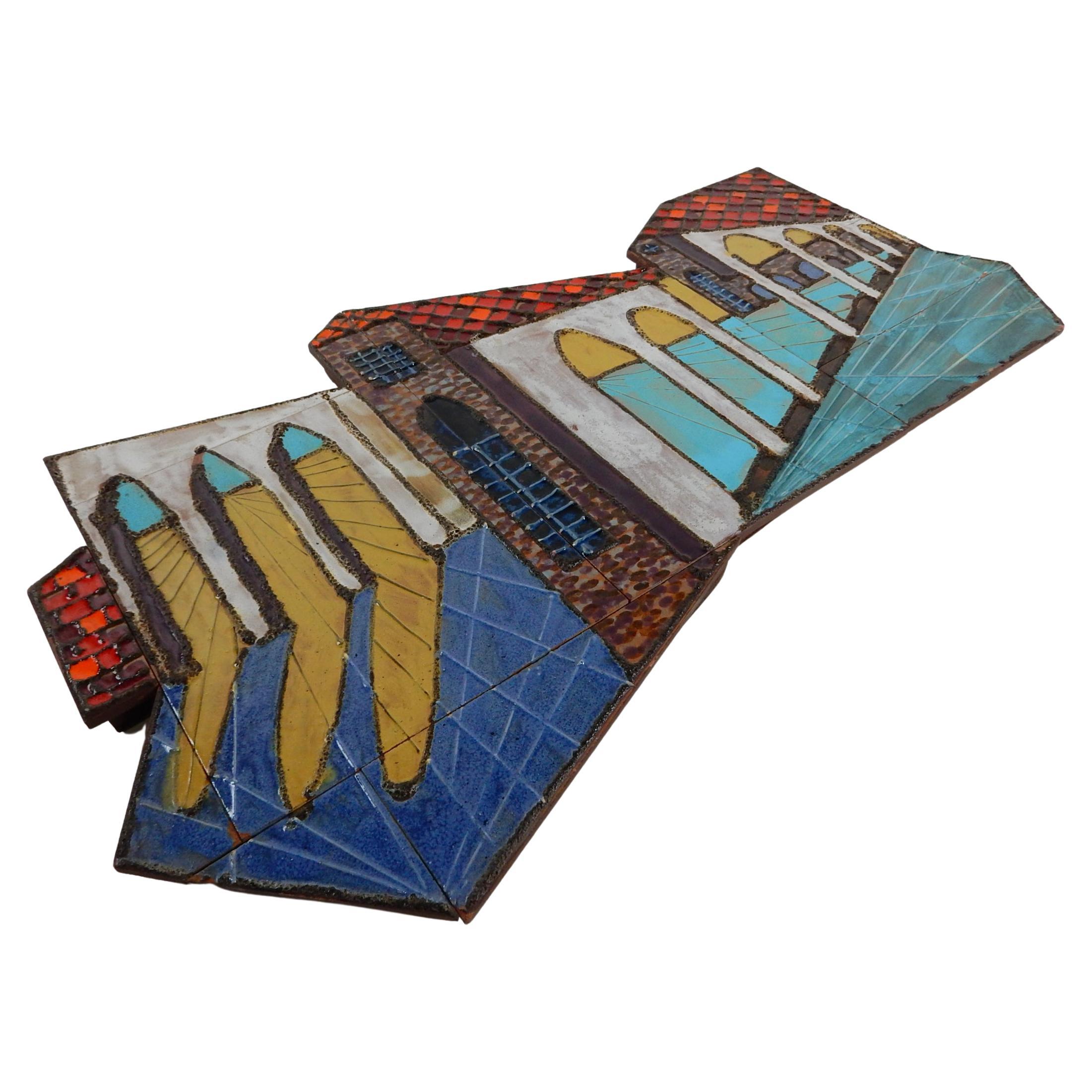 Large asymmetrical architectural ceramic tile wall art sculpture. 
Beautiful color glazes of turquoise, red and blue.
Hangs on 2 D rings on back. Not signed. 
Sofa size measuring 3 feet wide(36in) X 22in.