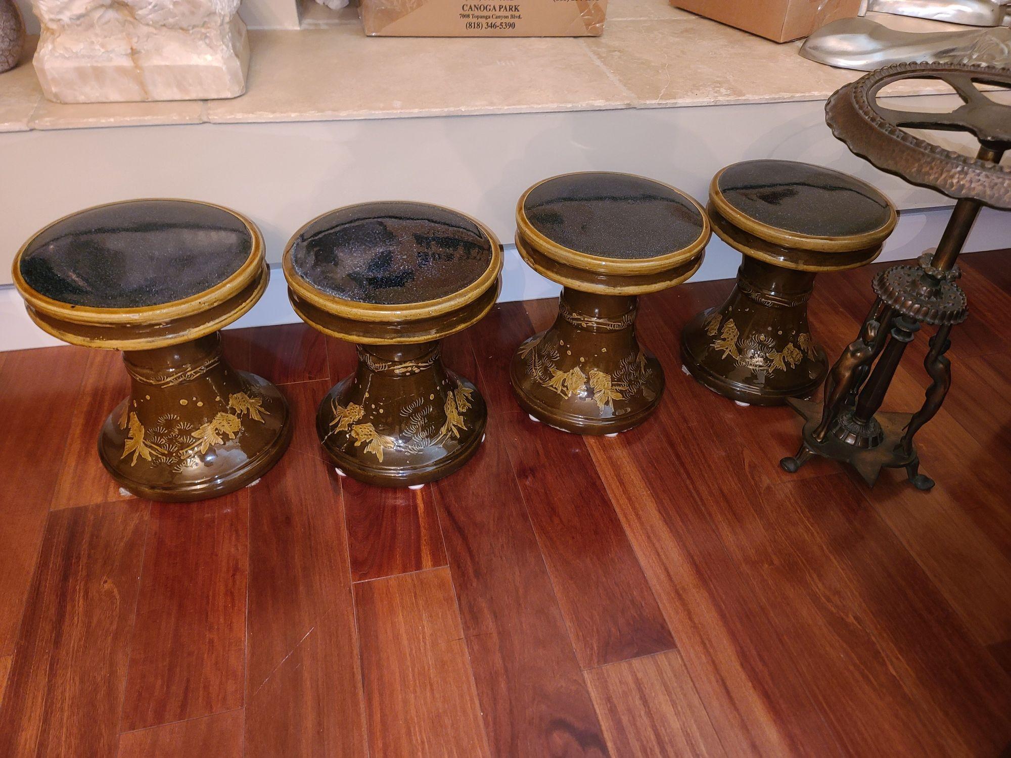Original set of four 1970s California Pottery hour glass Garden Stools in a brown glaze with beige highlights featuring a relief of fish along the base of each stool.
1970, United States.