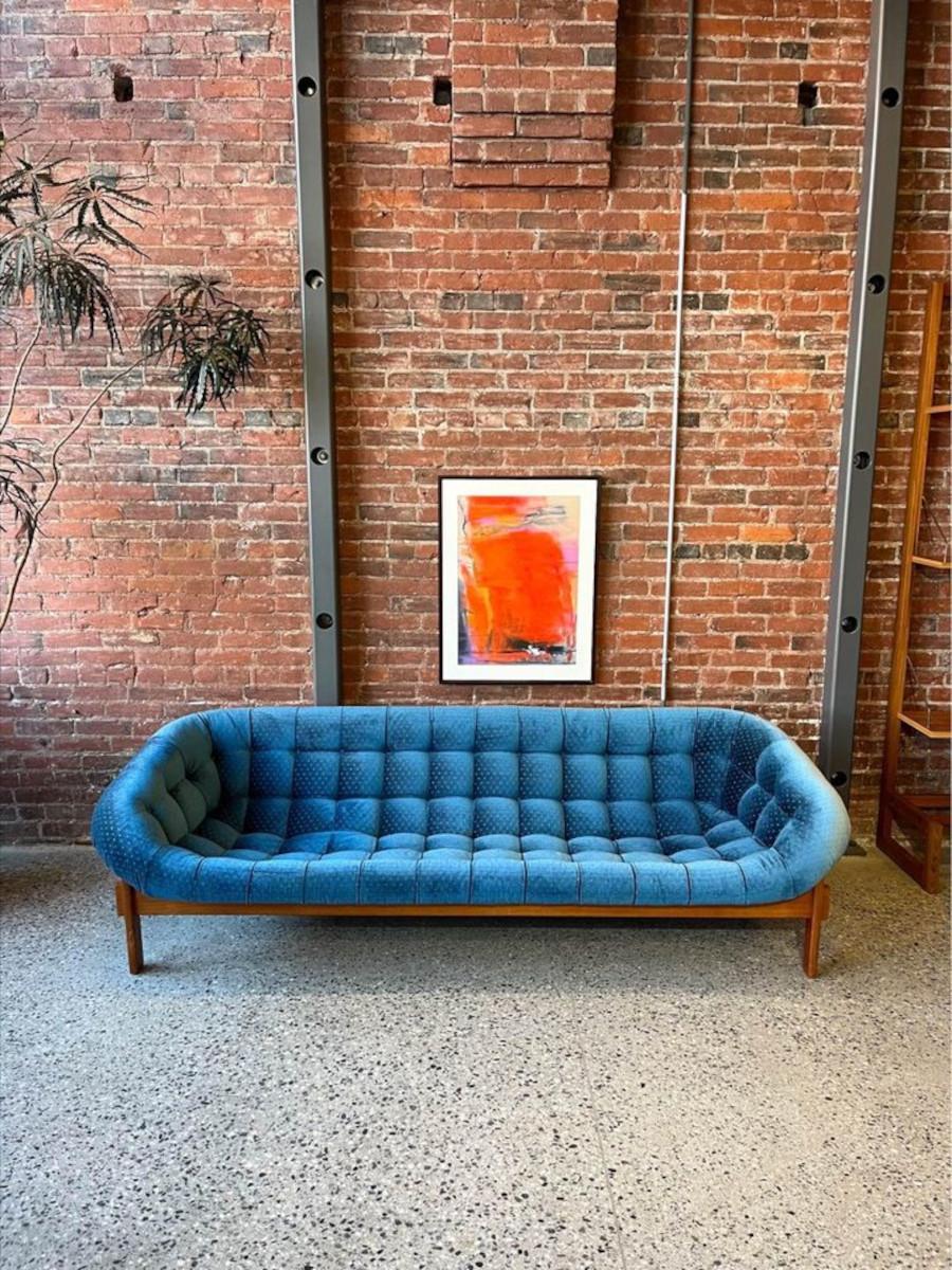 We are excited to present this 1970’s Huber & Co tub sofa, proudly crafted in Canada. Featuring an upholstered fiberglass seat resting on a sturdy teak frame, this design has gained recognition as an iconic piece of Canadian furniture over the past
