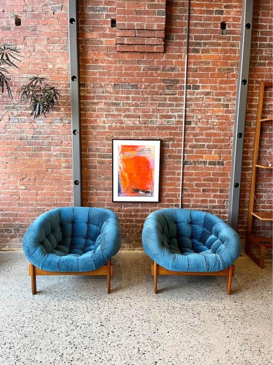 Step back in time with this pair of 1970's Huber & Co tub chairs, crafted right here in Canada. With its upholstered fiberglass seat supported by a teak frame, these designs have garnered fame as iconic pieces of Canadian design over the past decade
