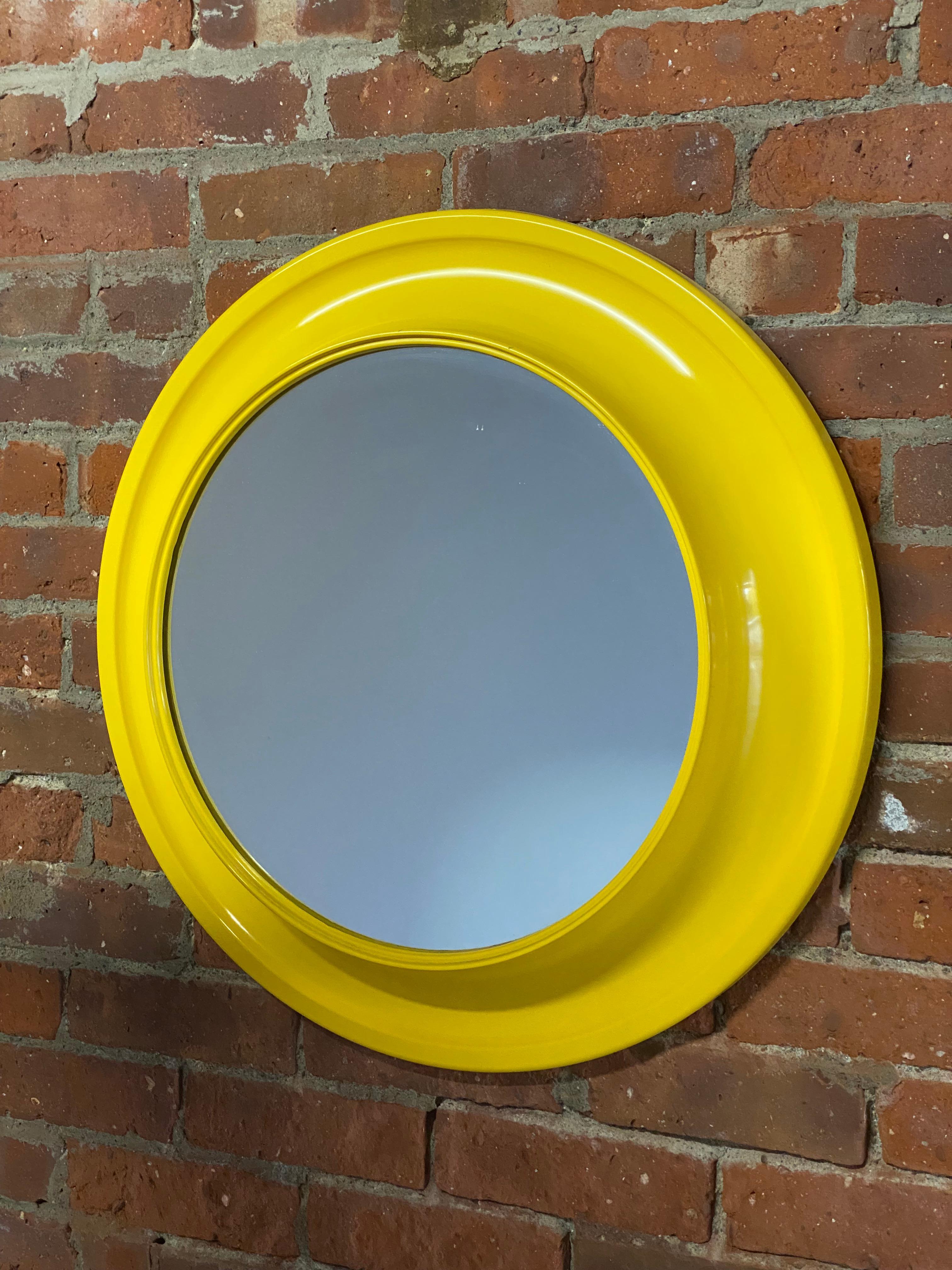 A wonderful canary yellow 1970s Pop Art mirror. Yellow plastic concave porthole style frame. Good overall condition with no visible cracks, hairline, fading, discoloration or smokiness to the mirror. 

Approximately 3.5