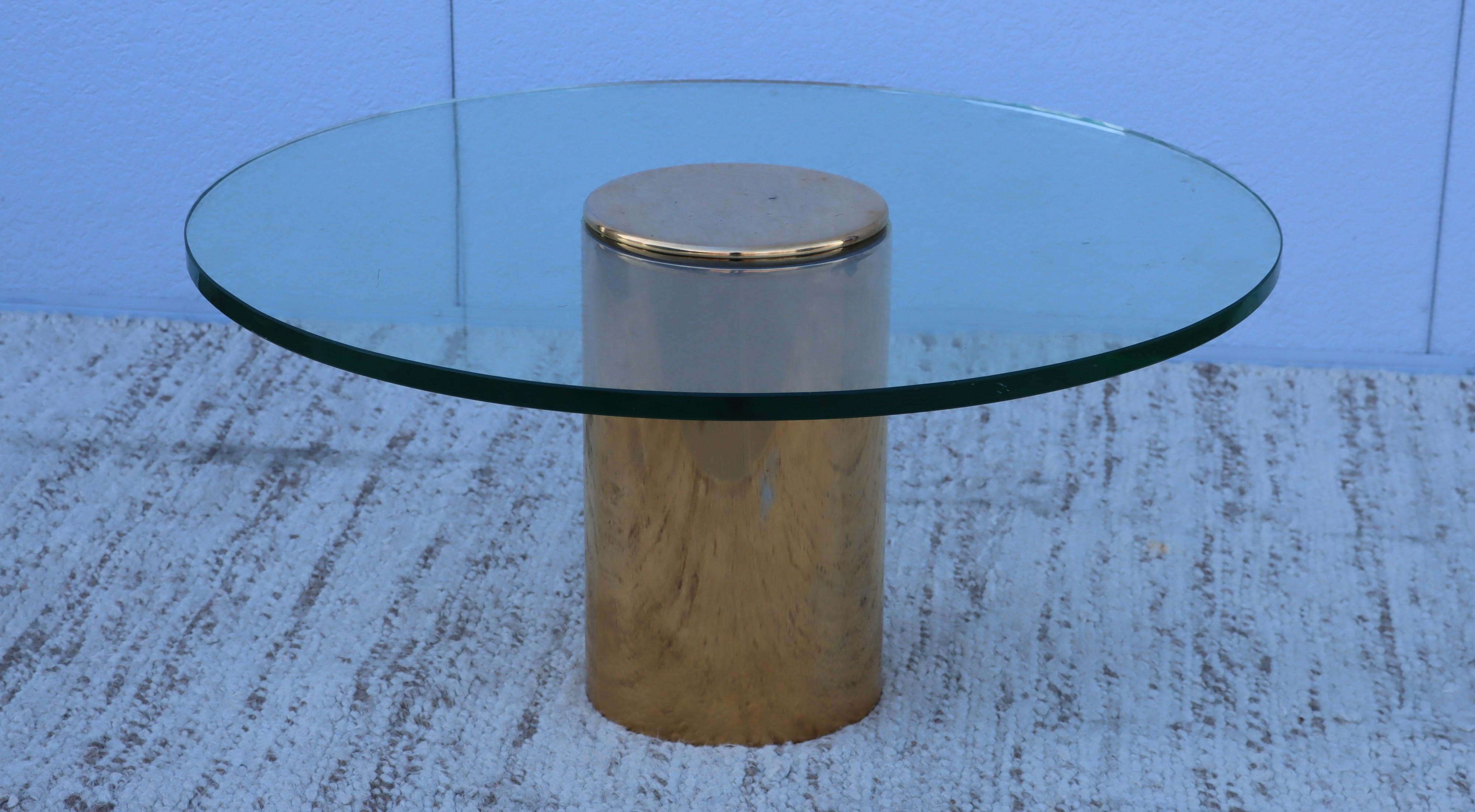 1970's Steel cantilevered base with glass top brass plated coffee table in the style of Pace, in vintage original condition with some wear and patina due to age and use, there is some wear to the brass finish and some wear to the glass.