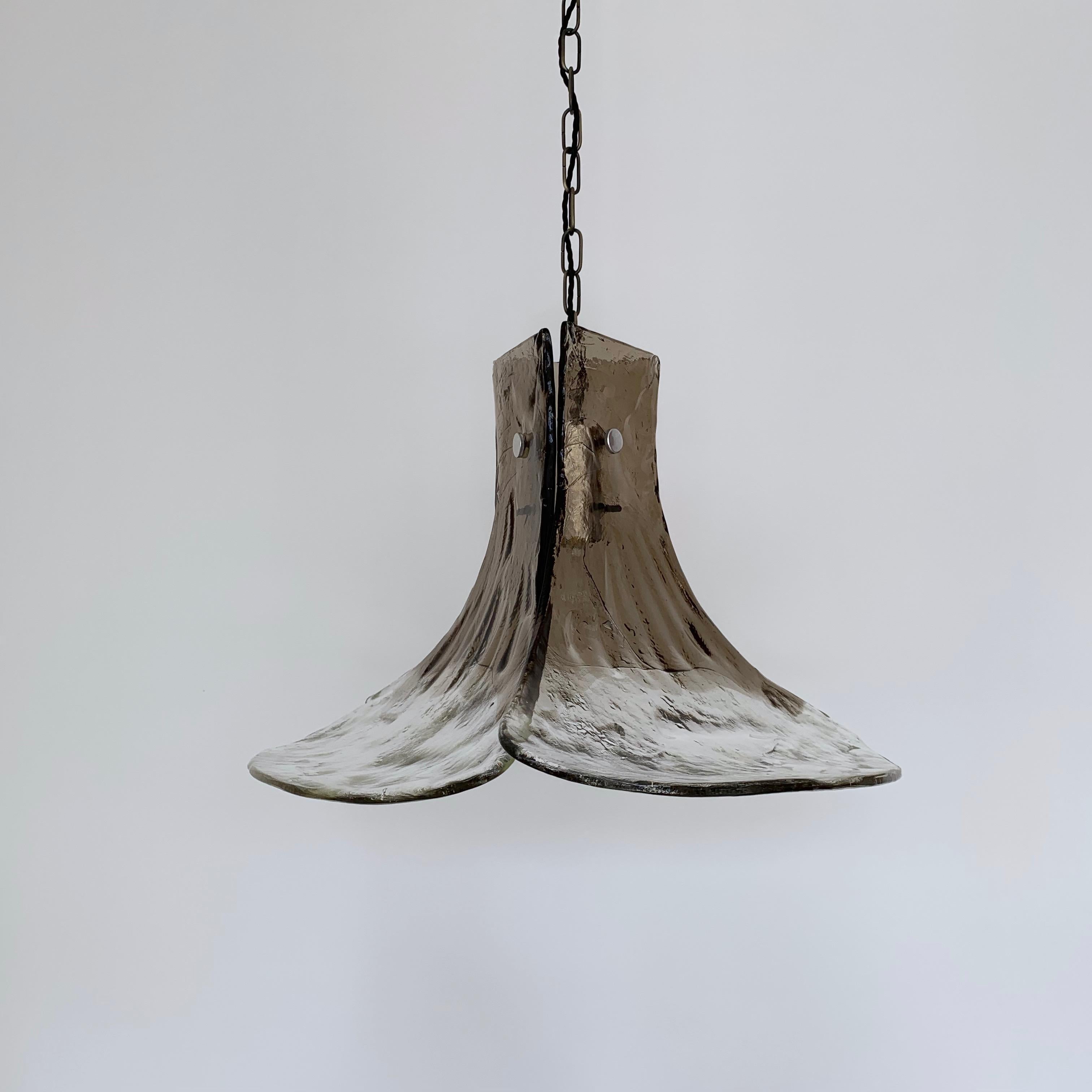 1970s Carlo Nason for Mazzega floral pendant in clear and smoked grey Murano glass. Three individual glass leaves mounted on a metal frame. Rewired with antiqued chain and black braided flex. This shade requires one B22 lamp. A matching ceiling