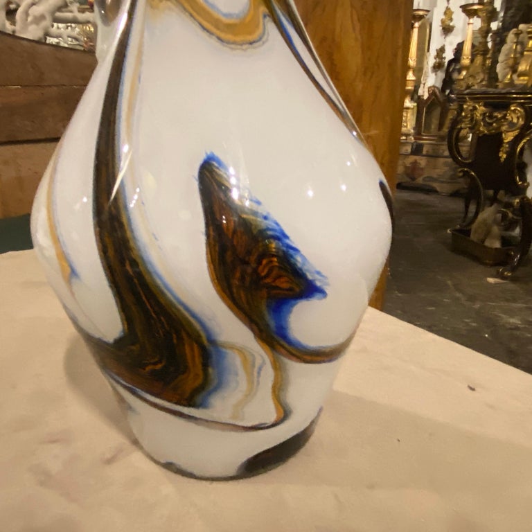 A white opaline murano glass jug made in Italy in the Seventies. The white, brown and blue glass it's in perfect condition.