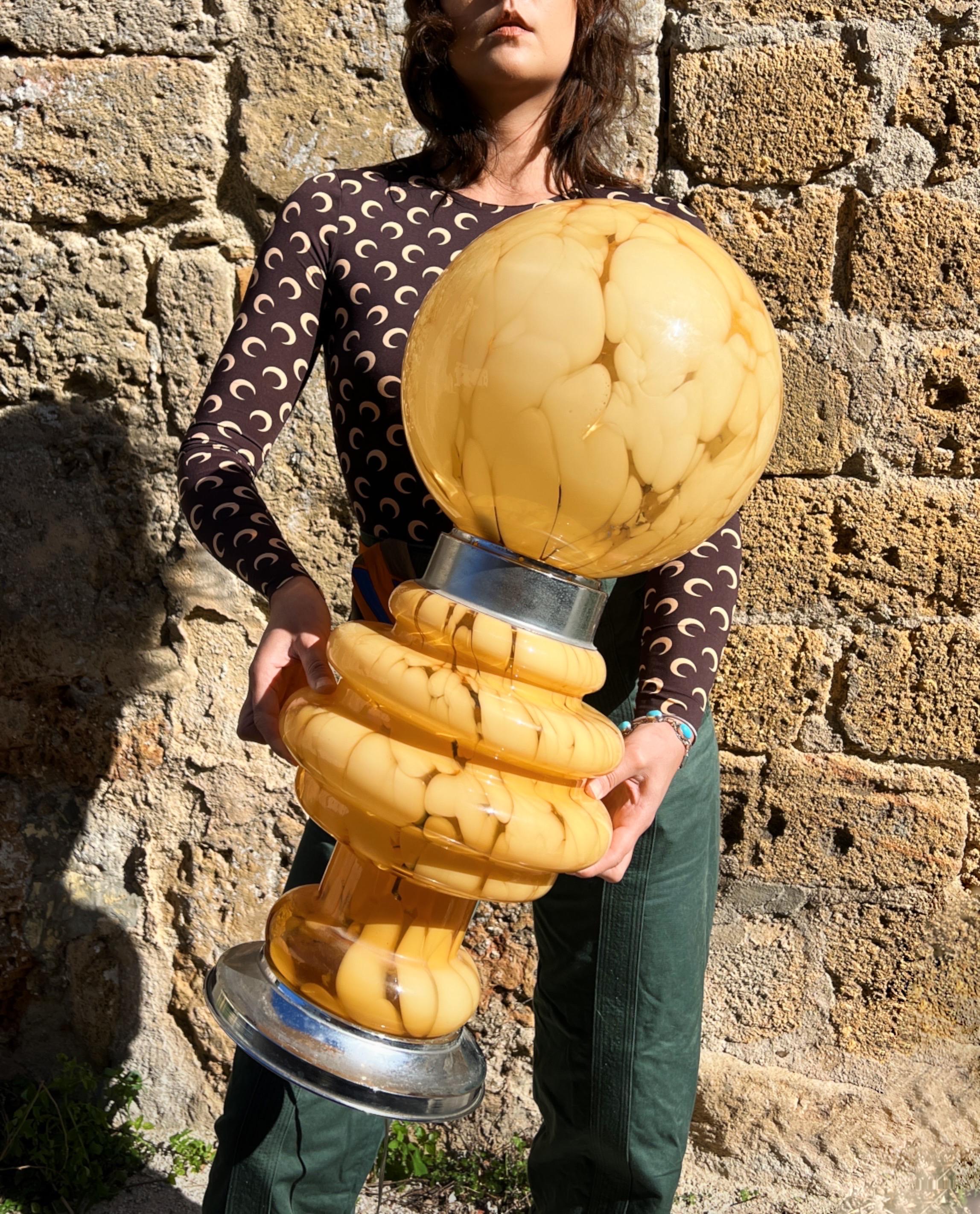 This beautiful table lamp by renowned Italian designer Carlo Nason is a striking example of 1970s glass design. Crafted in softly marbled beige glass the lamp showcases Nasons signature use of organic form and material mastery. Its rounded