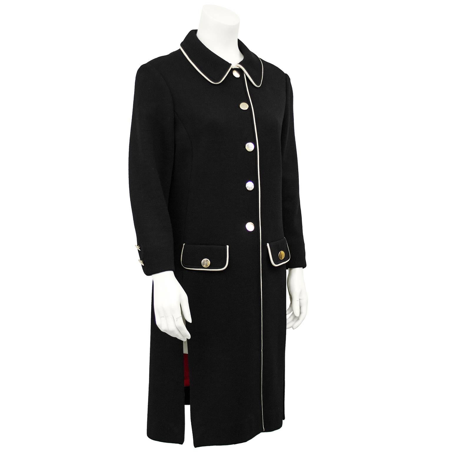 1970s Carnaby black Mod look knit coat. Cream trim, gold buttons, faux patch flap pockets, red sateen lining and tunic like sides slits. Amazing seasonal transition piece. Excellent vintage condition. Fits like a US 6. Dry cleaned and ready to wear