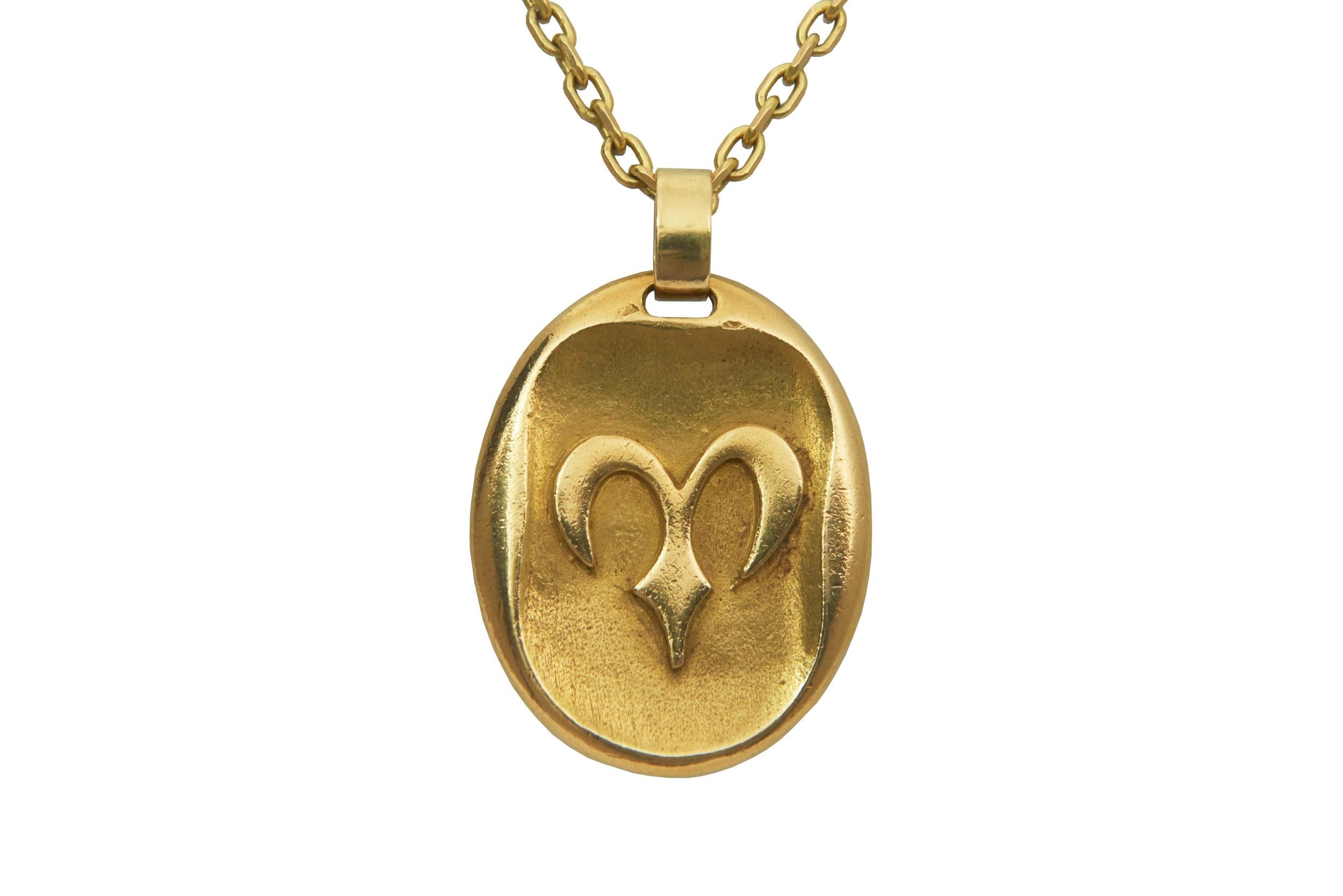 A rare and highly collectible, vintage, 18 karat yellow gold Aries zodiac pendant, by Cartier, c. 1970. Stamped Cartier Paris, 750, French assay marks, (partial) George Lenfant maker's mark. The pendant is 1.5-inch long, and 34.88 grams,. 

Aries is