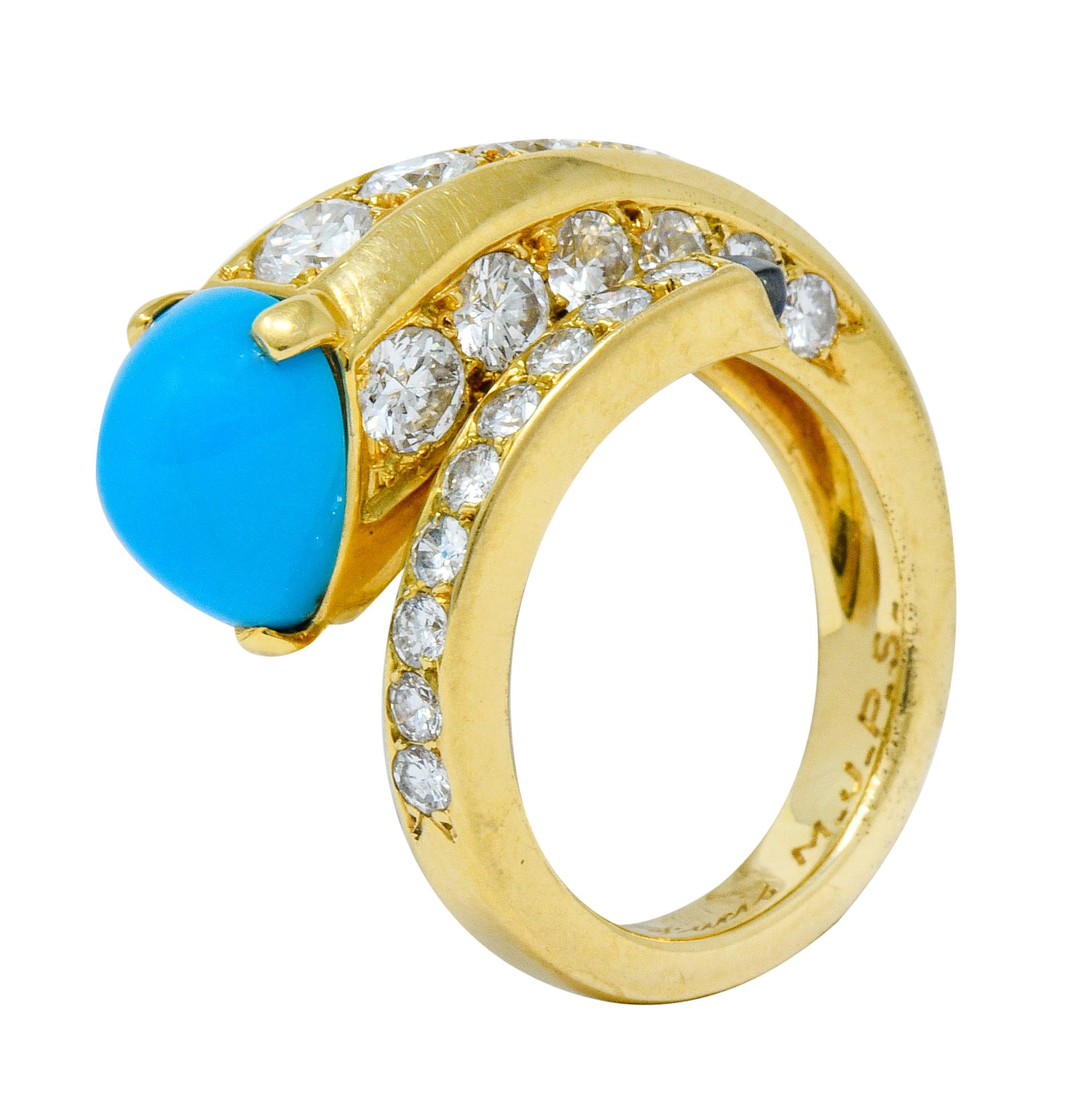 Bypass style ring terminating on one end as a pear cut turquoise cabochon while opposing end terminates as a small sugarloaf sapphire

Turquoise is an opaque robin's egg blue exhibiting no matrix while sapphire is a medium-dark royal blue