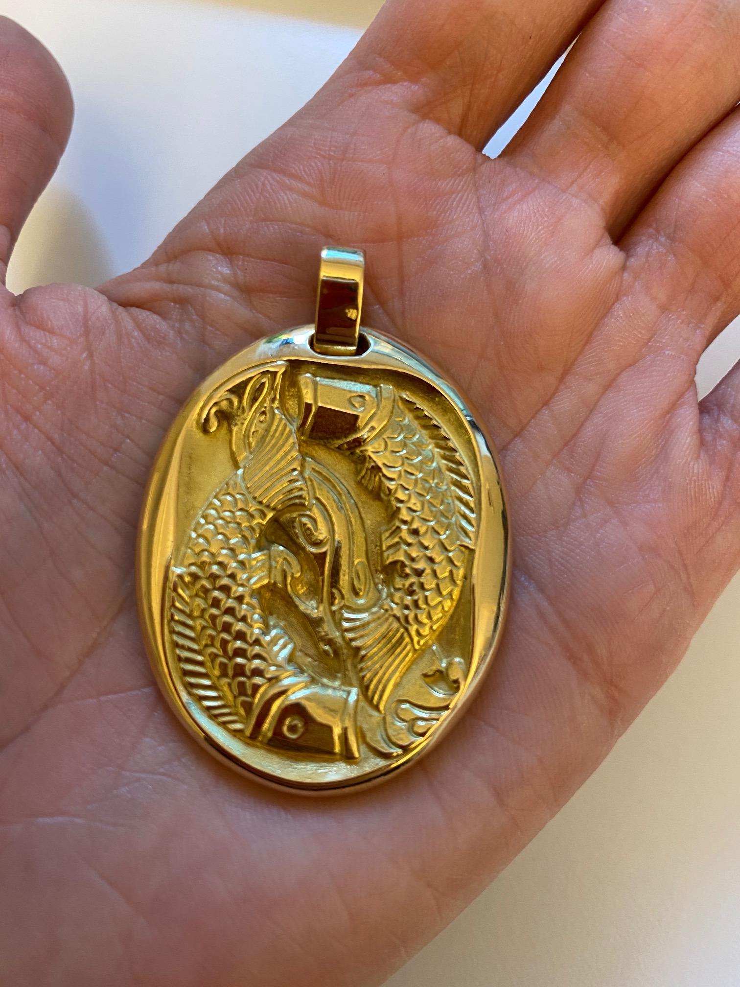 An 18 karat gold Pisces zodiac pendant, by Cartier, 1970s.

Signed Cartier Paris. Stamped with French export marks & maker's mark for George L'Enfant.