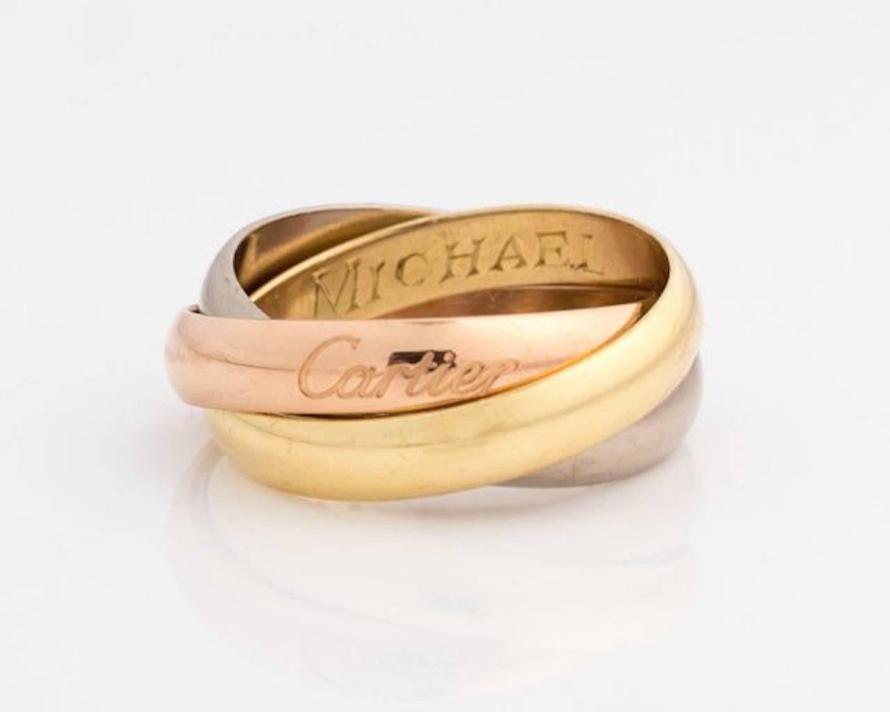 1974 Cartier Tricolor Trinity Ring - 18k Gold, Rose Gold, White Gold, Yellow Gold

Features 3 interlocking 18 karat Gold bands. 
The rose gold band has the hallmark 