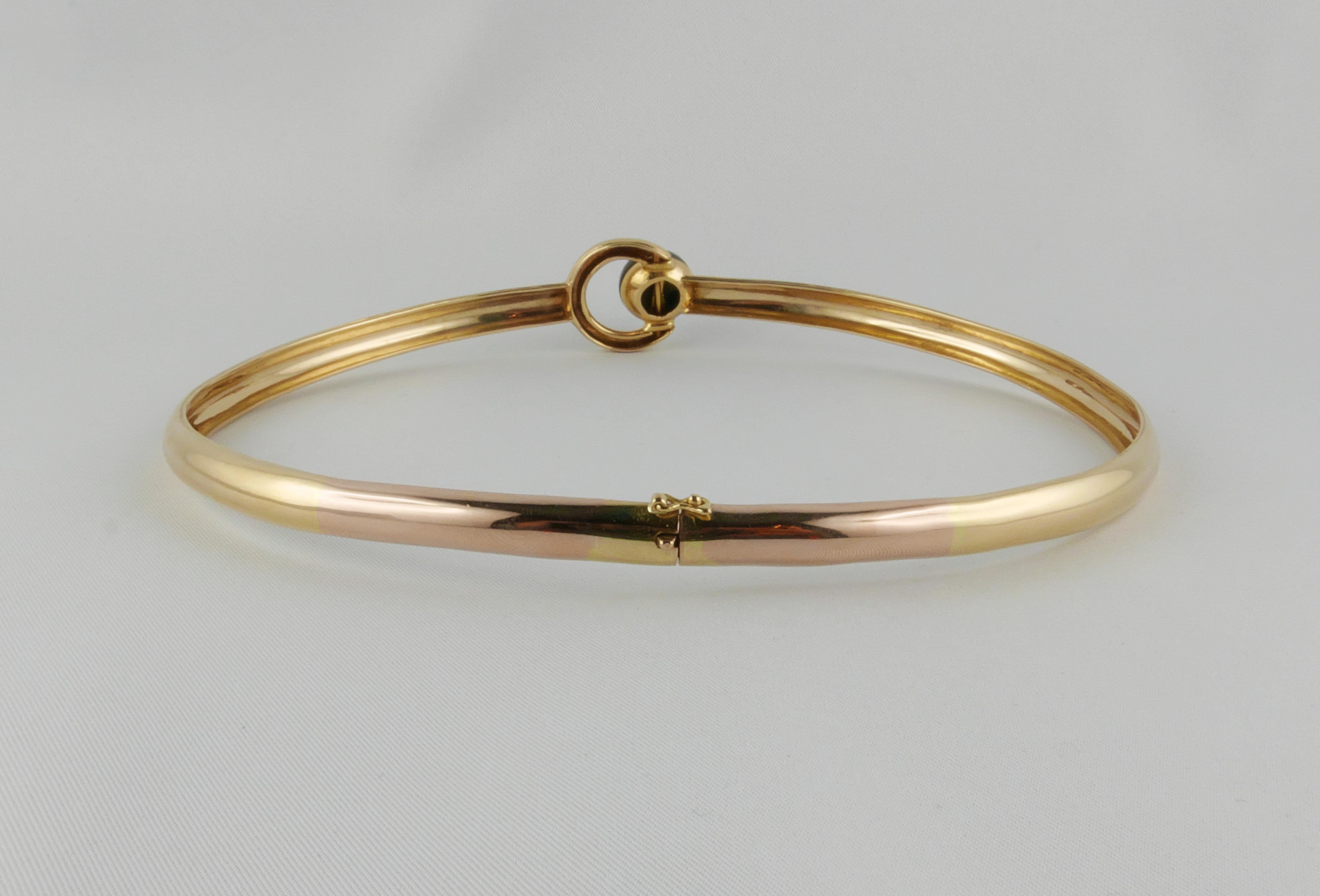 Chic and timeless 1970’s Cartier Choker  beautifully crafted in 18k Yellow Gold. This elegant and extremely stylish collar centered with an Onyx round  cabochon has an essential but still very sleek design. It is a wonderful collector's piece, a