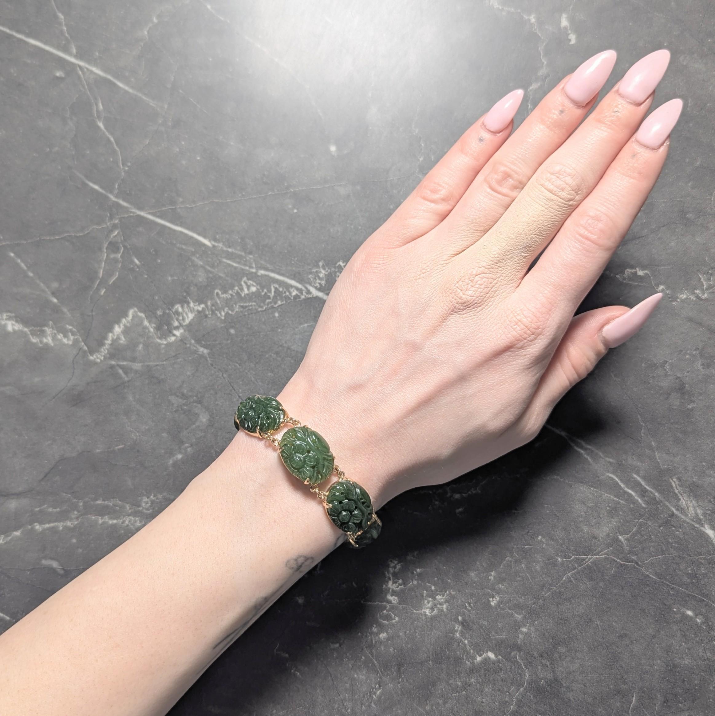 Comprised of oval shaped jade cabochon links carved to depict flowers
Measuring 15.0 x 20.0 mm - translucent dark mossy green in color
Set with talon prongs on pierced links connected via jump rings
Completed by an oval shaped clasp pierced with