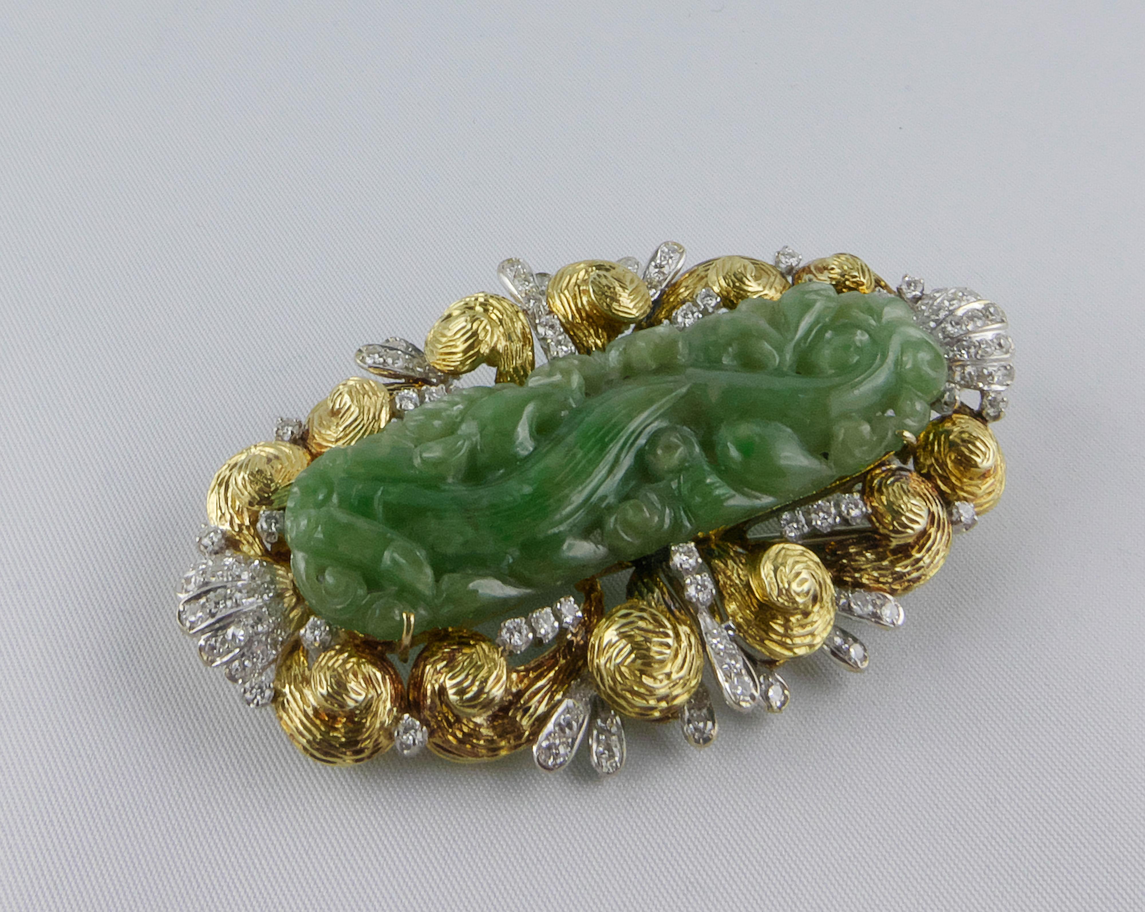 An elegant  1970s 18k Gold Brooch set with Diamonds and an intricately and beautifully hand-carved oval crafted out of a stunning piece of green Jade. The several grooves and the soft green shades of the Jade giving a three-dimensional