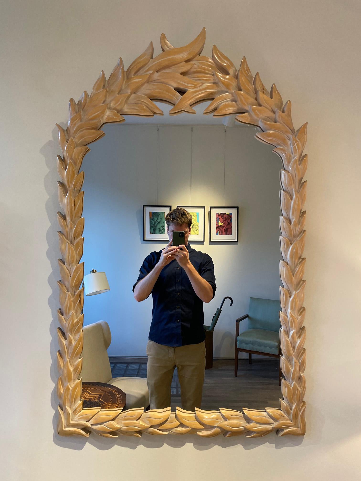 A large carved wood palm leaf mirror, in the manner of Serge Roche.
Italy, 1970s.