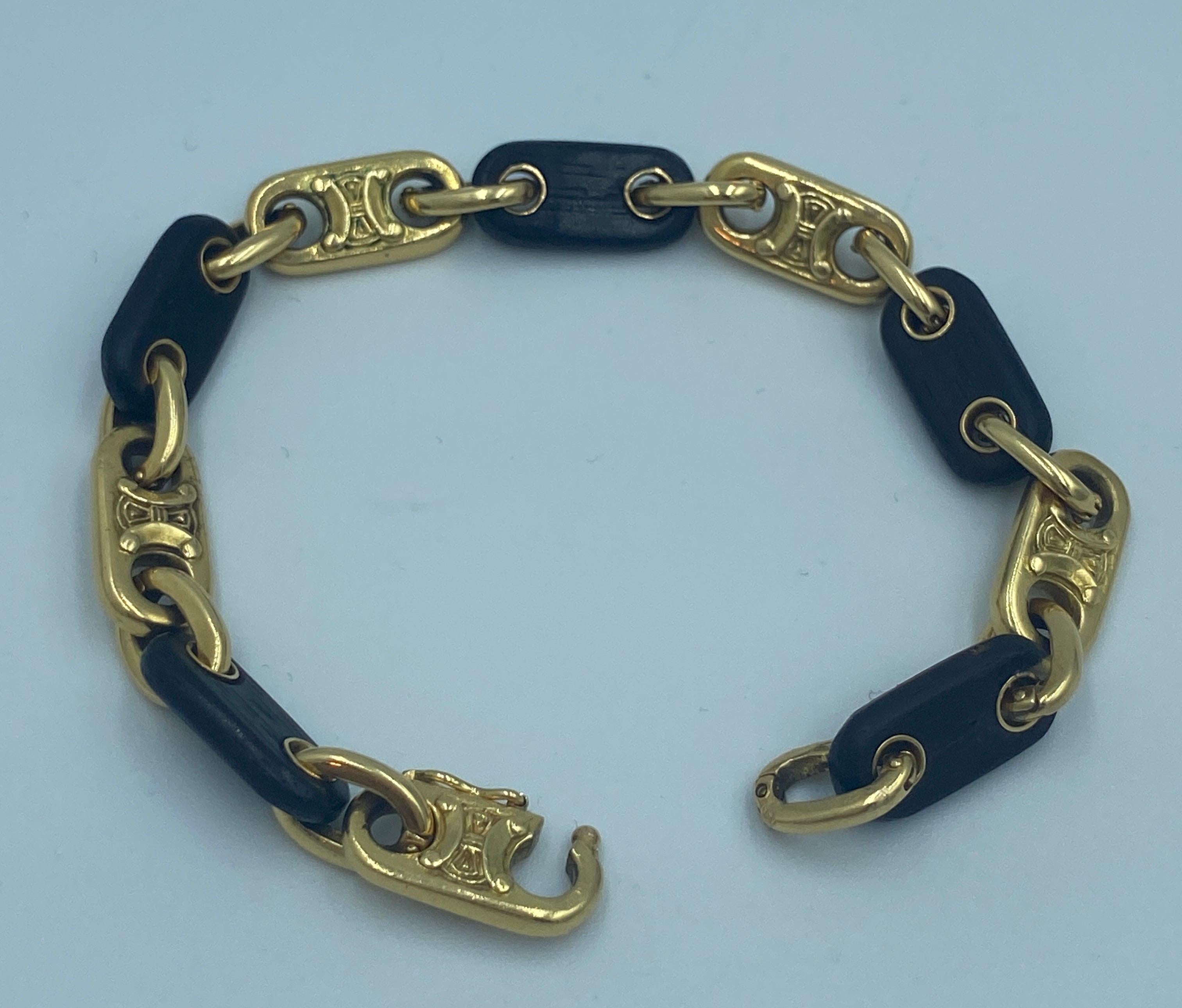 This bracelet made in 1970s by Celine is a highly wearable piece with interlocking 18k gold and ebony links. The set also has a necklace which is listed separately on 1st Dibs. A photo of the necklace is included below.
