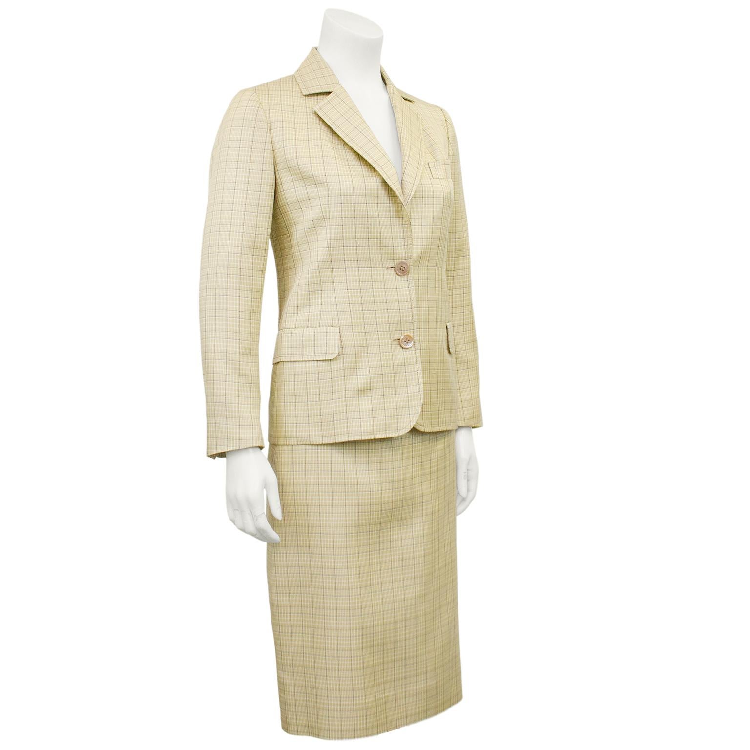 1970s Celine silk skirt suit. Beige, white and black all over glen check. Jacket is a classic blazer with a notched collar, single horizontal slit pocket at bust, flap pockets at hips. High waisted pencil skirt with beige leather faux belt detail at