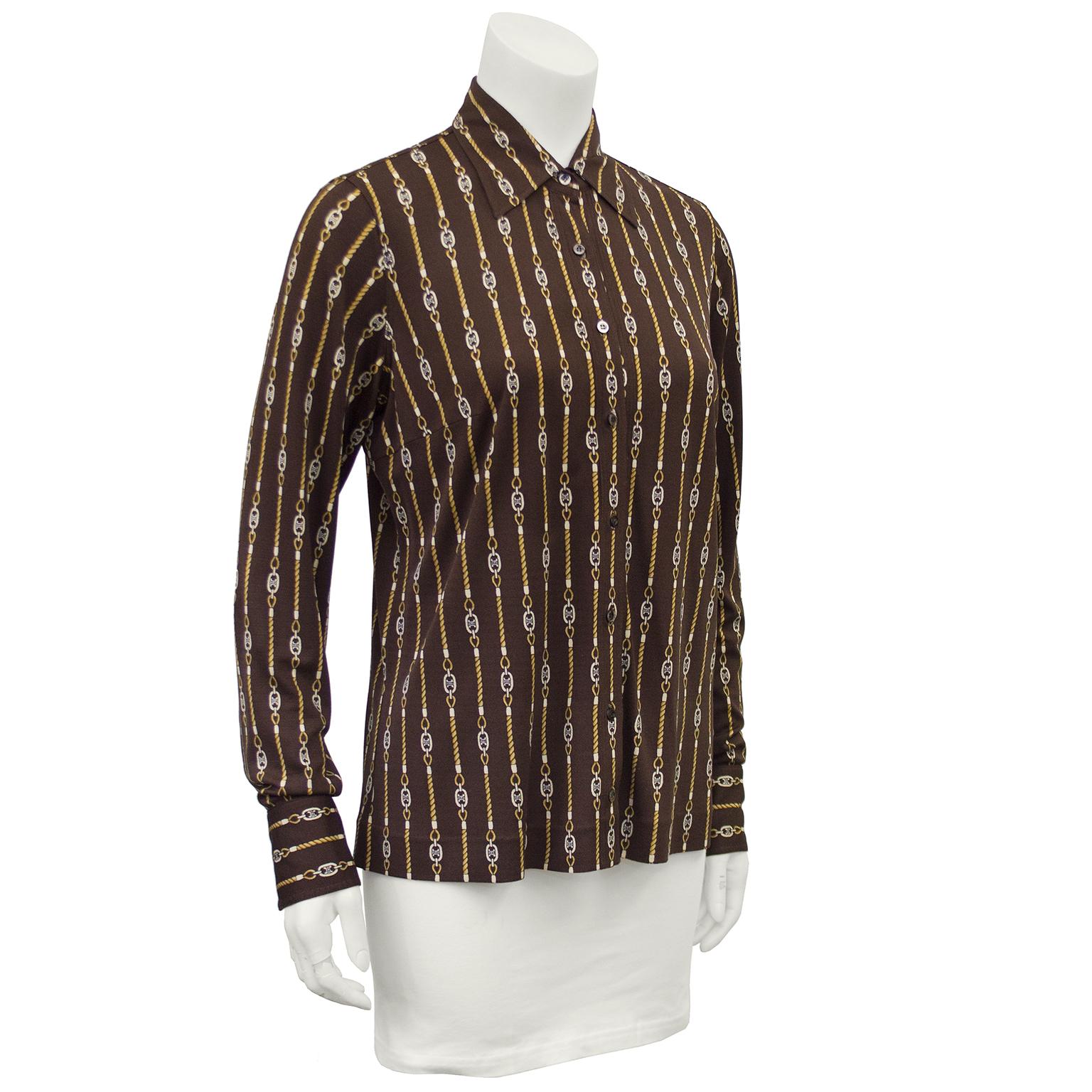 1970s Celine brown poly blend chain printed button down shirt. The all over print is the classic Celine logo cream buckle with gold twisted rope links traveling vertically down the front, back, collar and sleeves. The cuff features the same print