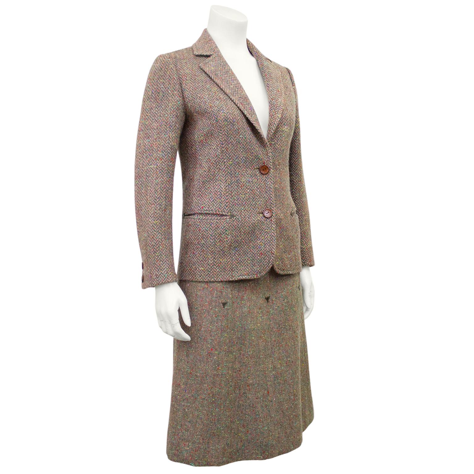 1970s Celine brown and multi colour herringbone wool skirt suit. Classic herringbone wool blazer with notched collar, horizontal slit pockets and branded brown buttons. Skirt is matching wool in Donegal pattern high waisted and A-line. Brown leather