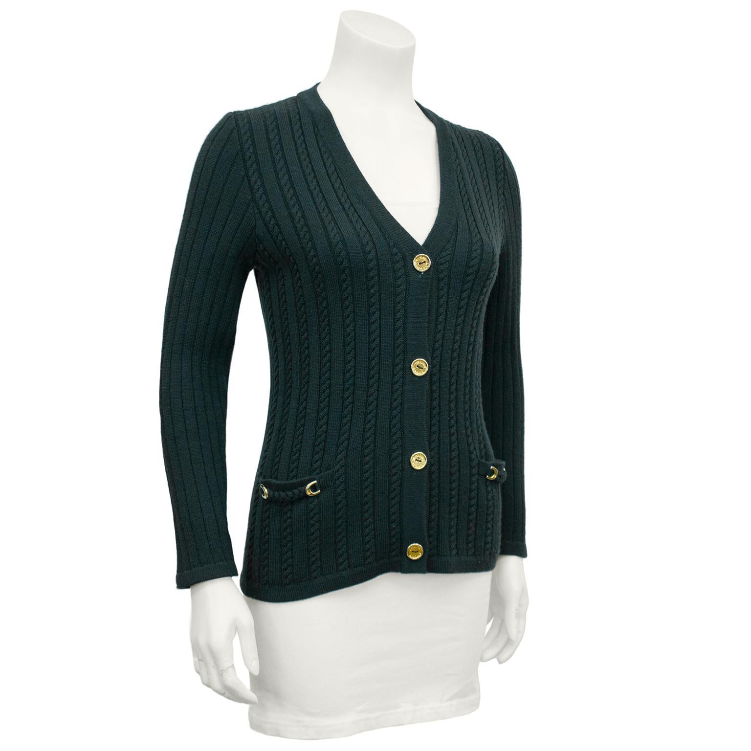 Hunter Green wool cable knit cardigan with gold Celine logo gold buttons and gold chain details at flat pockets. In excellent vintage condition, marked FR 38. Fits like a US 2-4.