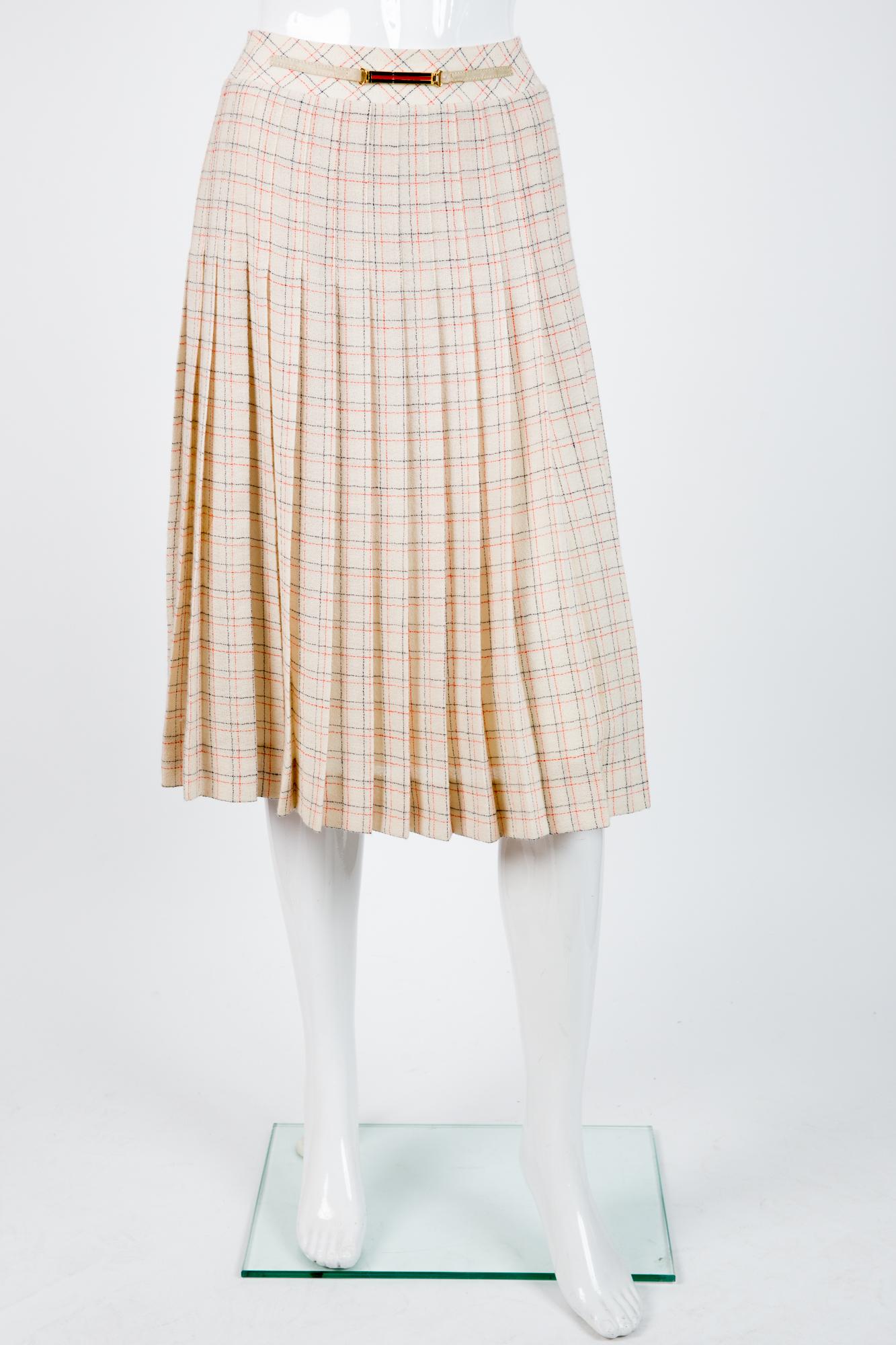 Celine ivory wool skirt featuring a navy and red check pattern, a center back zip, a front leather and music buckle, a logo lining. 
80% wool
20% polyamide
In excellent vintage condition. Made in France.
Label size 38fr/US6 /UK10 but can fit a 36fr/