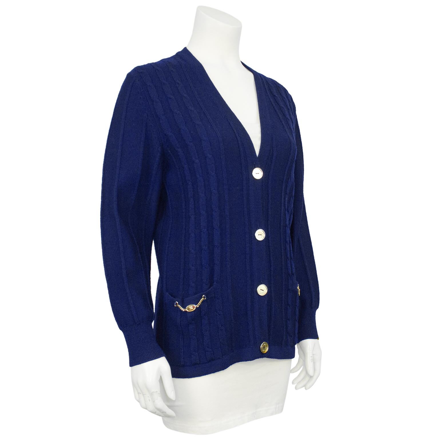 Celine navy wool cable knit sweater from the 1970s. From the Ira Berg Boutique in Toronto, Canada. Gorgeous navy wool with gold accent buttons and signature chains on the front patch pockets. Buttons are engraved with 