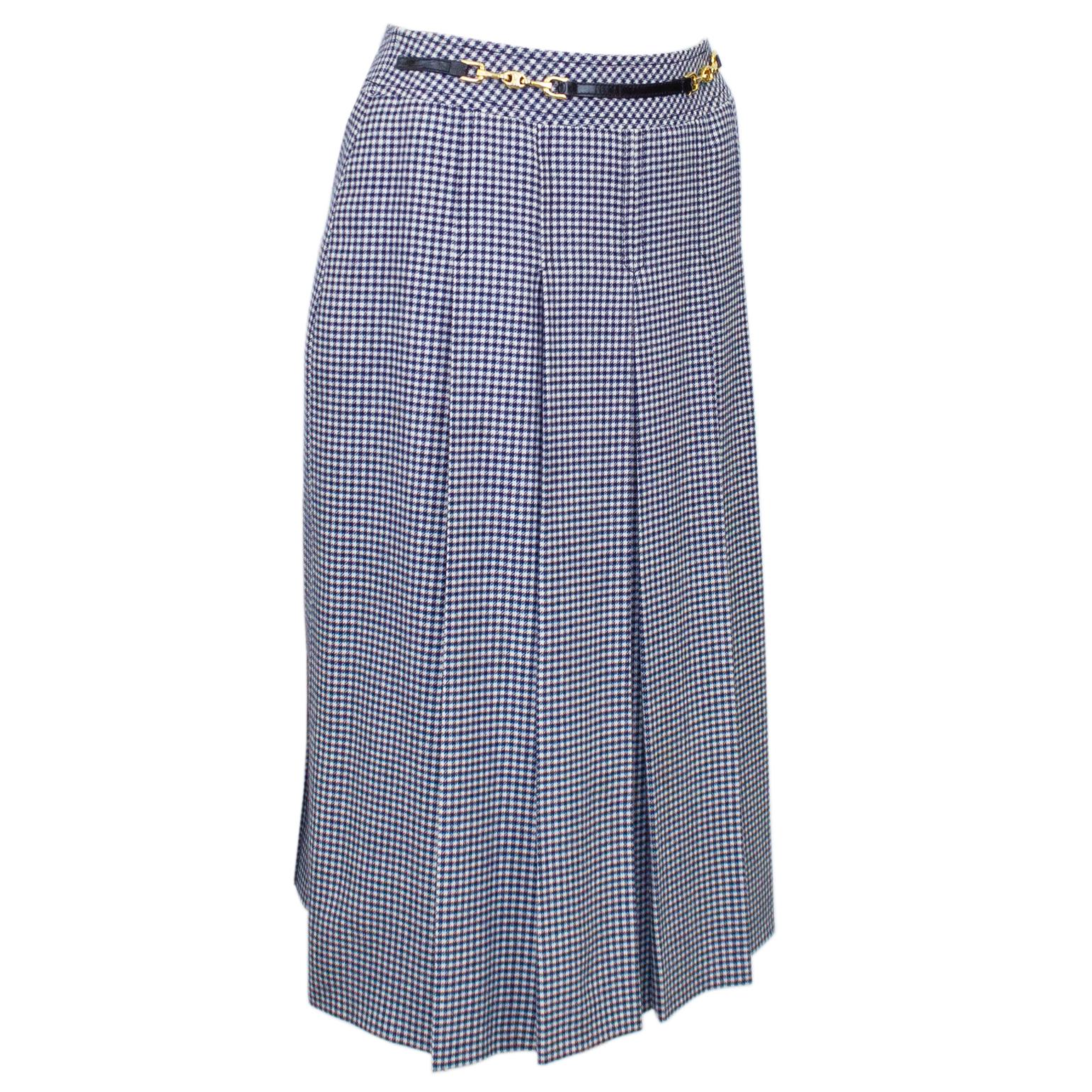 Celine navy wool stitched box pleat skirt from the 1970s. The mini houndstooth print is accented with the iconic Celine waist buckle. In excellent condition, fits like a US 2/4. Zips up the back and fully lined in CELINE printed navy silk. 

Waist