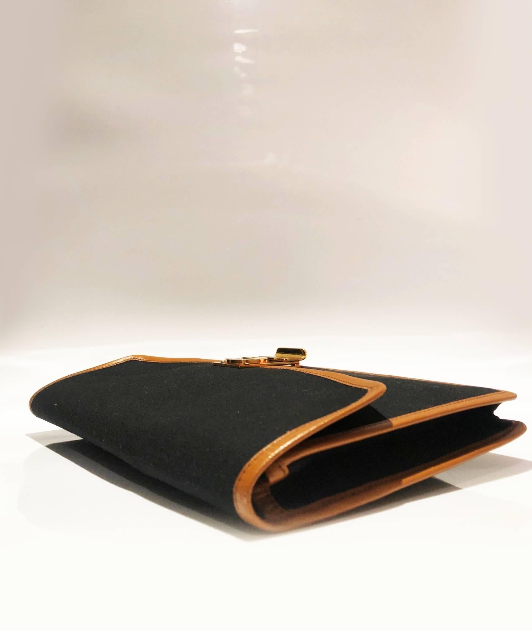 Celine Paris envelope clutch bag, black canvas with brown leather detailing,  heavy gold clutch C logo clutch closure, 2x internal compartments, zip closure, Made in France 

 Condition: vintage, 1970s/1980s, the bag is in nearly immaculate state 
