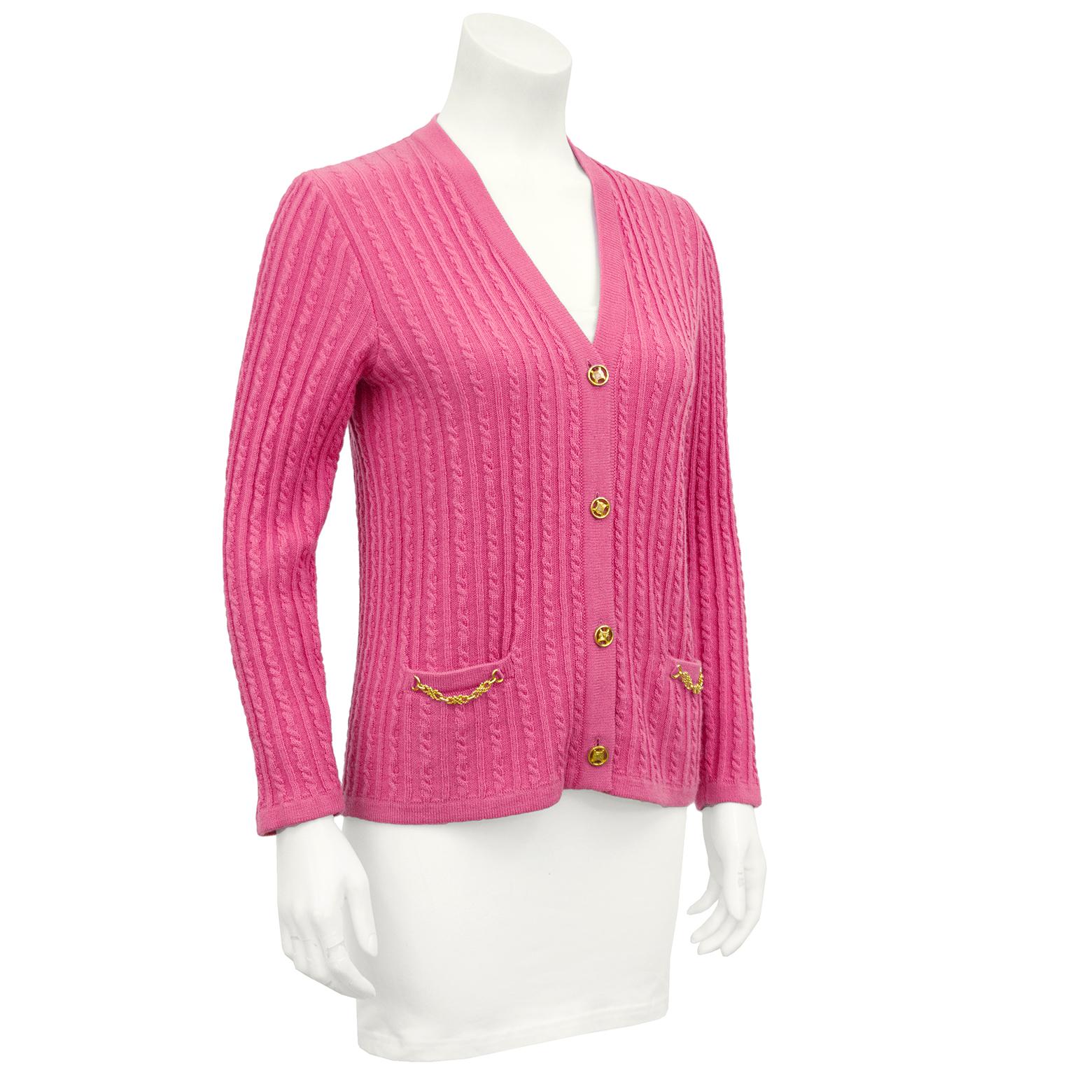 Pretty in pink 1970's Celine cardigan. Wool cable knit with gold Celine logo gold buttons and gold chain details at flat pockets. In excellent vintage condition, marked FR 38. Matches our 1970's Celine Pink Wool Pleated Skirt. 
