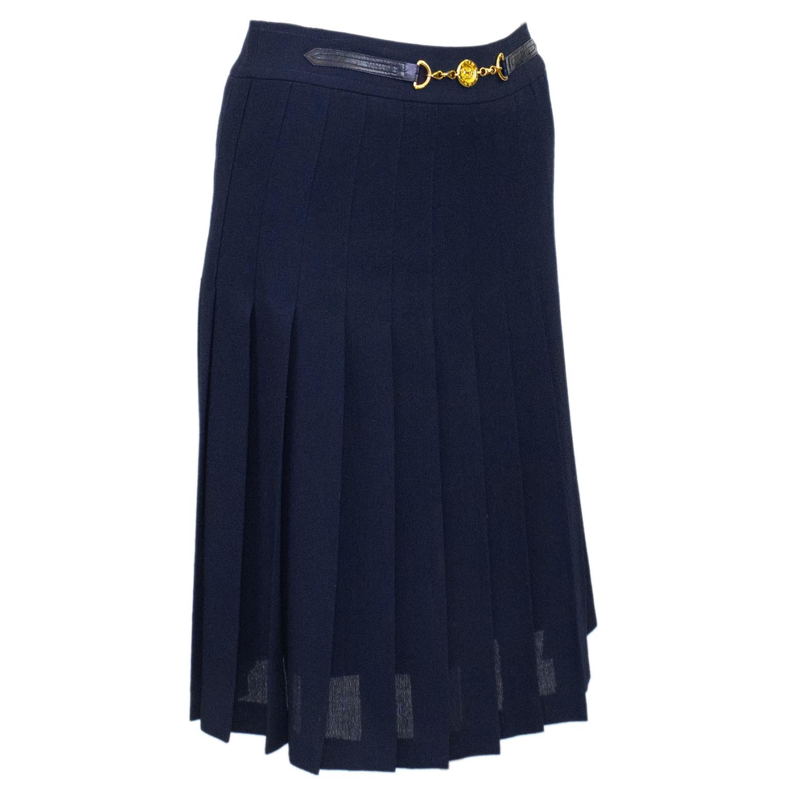 1970's classic Celine navy blue wool gabardine pleated skirt with half navy leather and gold belt at waistband. Vintage Celine horse and buggy logo gold metal coin centre of belt. Overall A line shape. In excellent condition, back zipper with hook
