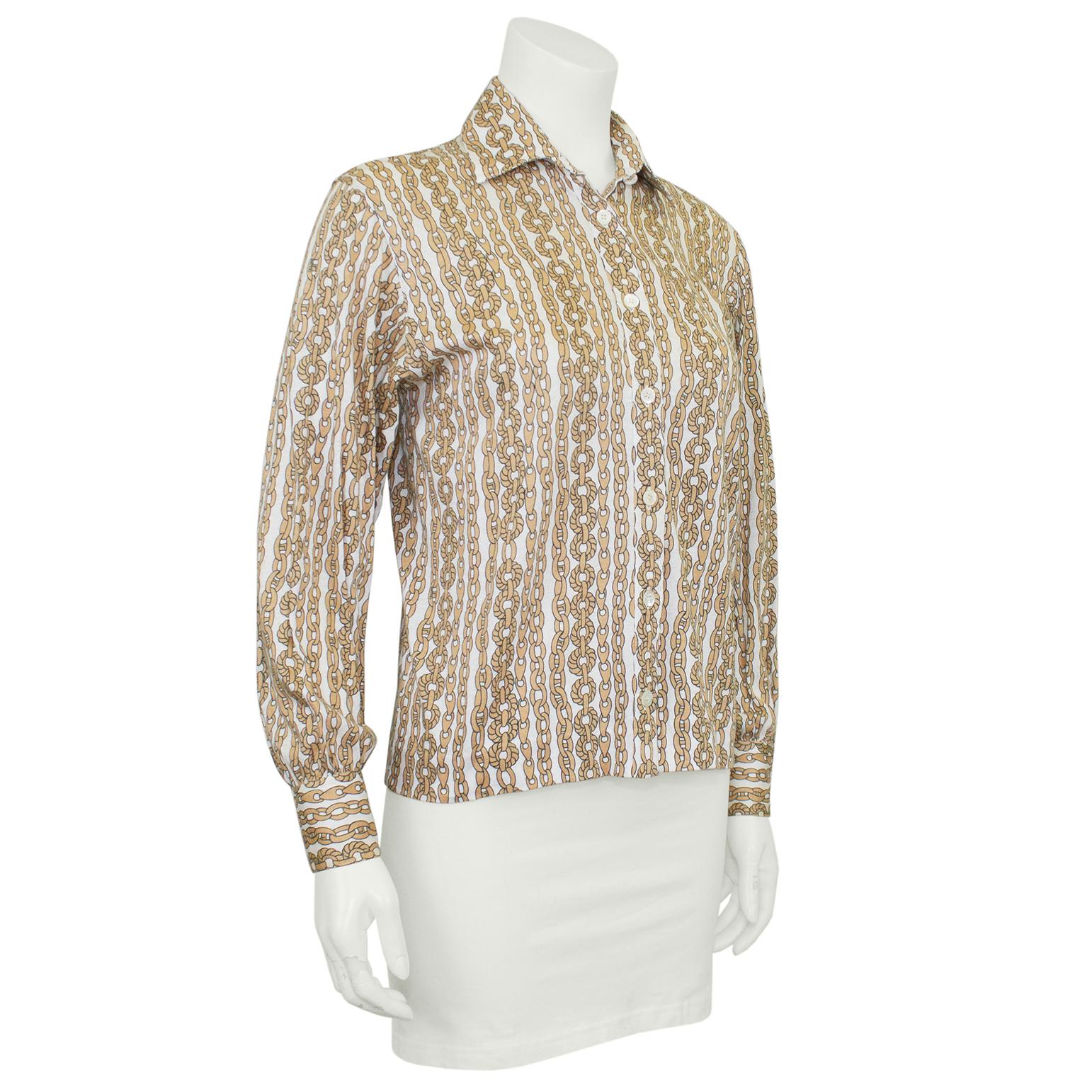 Classic Celine button down cotton top from the 1970s for the Canadian boutique Ira Berg. The blouse features an iconic Celine motif of vertical chains in light beige/taupe on a white background. Perfect with jeans or tucked into a classic Celine