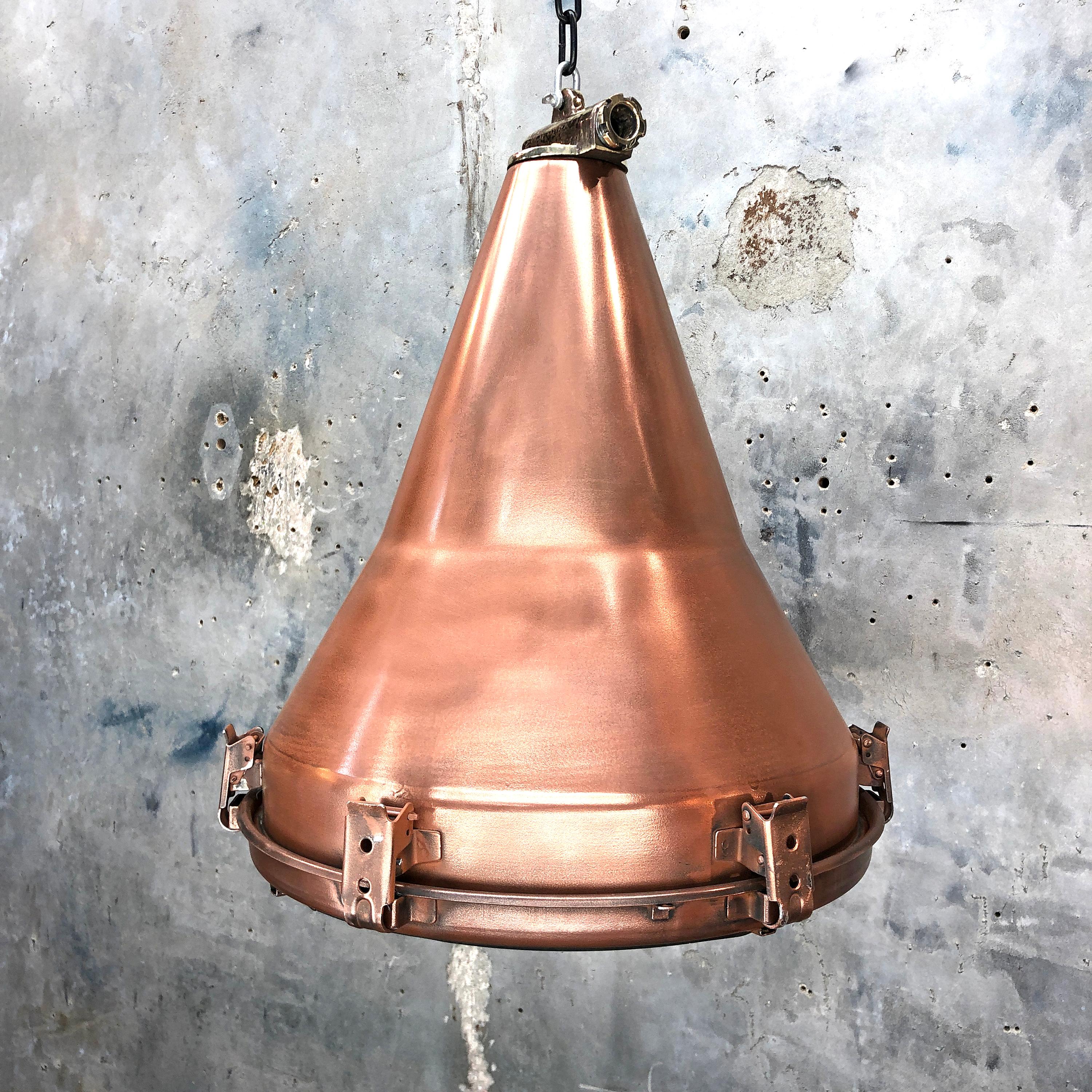 A retro Industrial copper ceiling pendant.
 
A reclaimed Korean light fixture reclaimed from decommissioned cargo ships circa 1970. Originally used on masts and gantries to flood light the container deck.
 
Specifications
Diameter 42cm
Height