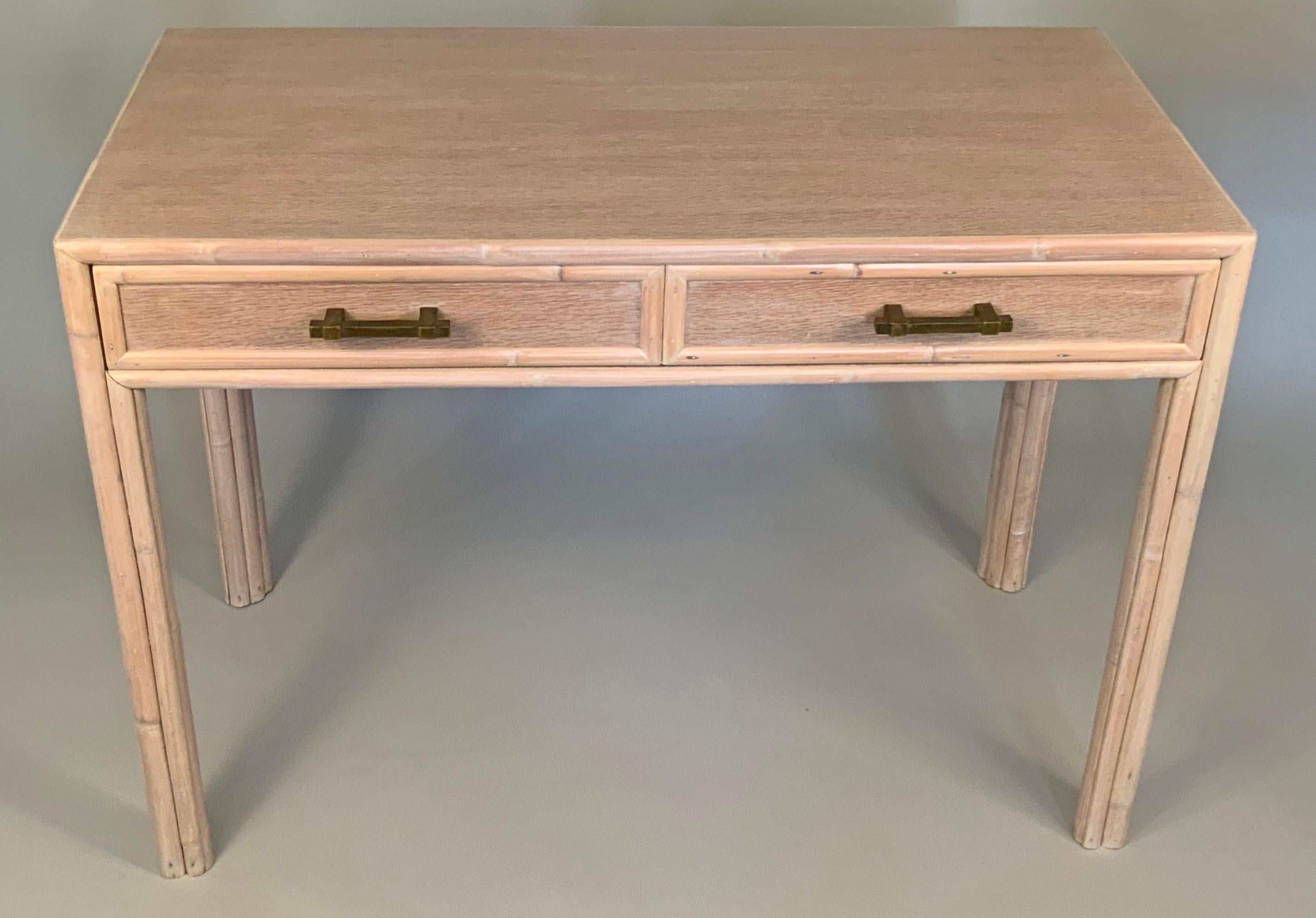 A beautiful 1970s writing desk by McGuire, with a very nice Cerused oak finish and rattan trim, with patinated brass drawer hardware. Wonderful details and scale.