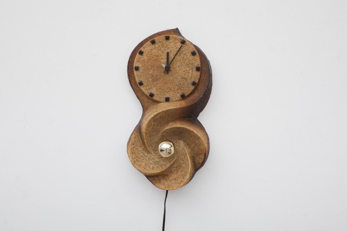 Heavy Brutalist 1970's wall mount chamotte earthenware clock with European (E14) candelabra socket. No mounting plate on back, however clock can be affixed to wall using a sturdy hook Clock is battery operated, with new clock mechanism, In original