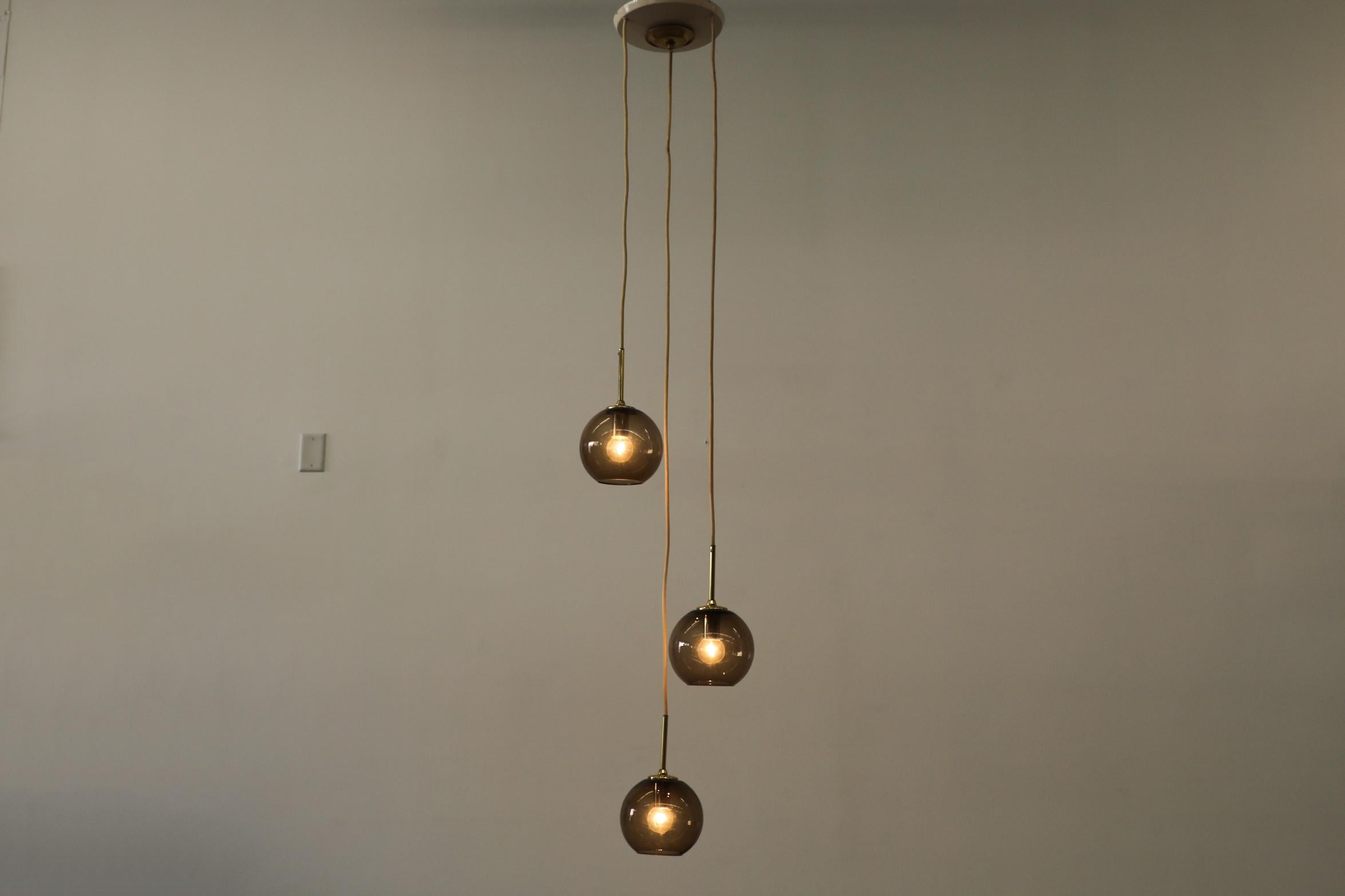 Dutch 1970s Chandelier with 3 Smoked Glass Globes, Brass Hardware and Triple Canopy For Sale