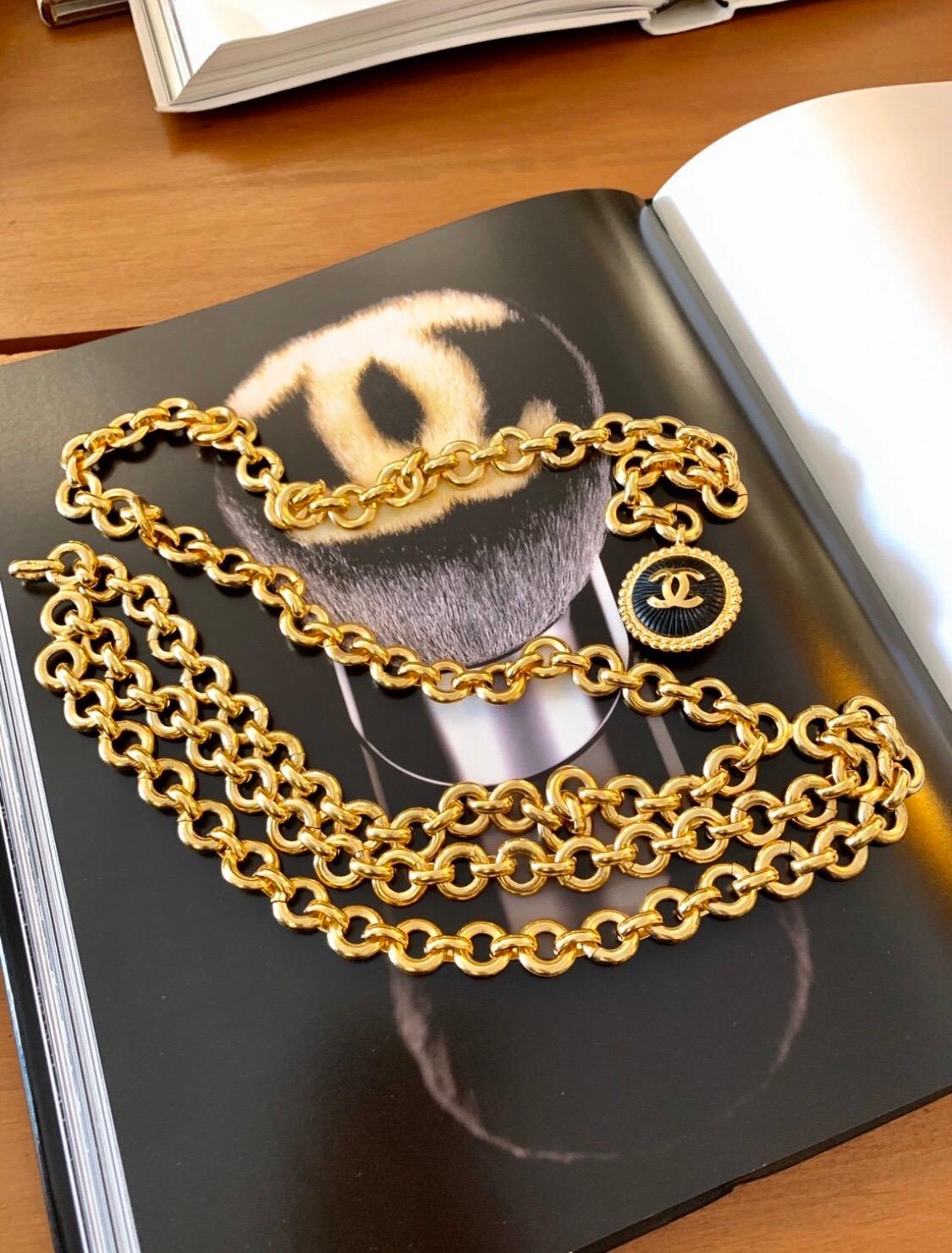 Rare 1970s Chanel gold toned chain belt features front triple chains and a gold toned CC resin charm. Adjustable hook fastening. It can be worn as a belt or a layered necklace. Stamped CHANEL. Chain Length 84cm (33 inches) Charm 3.2cm chain width