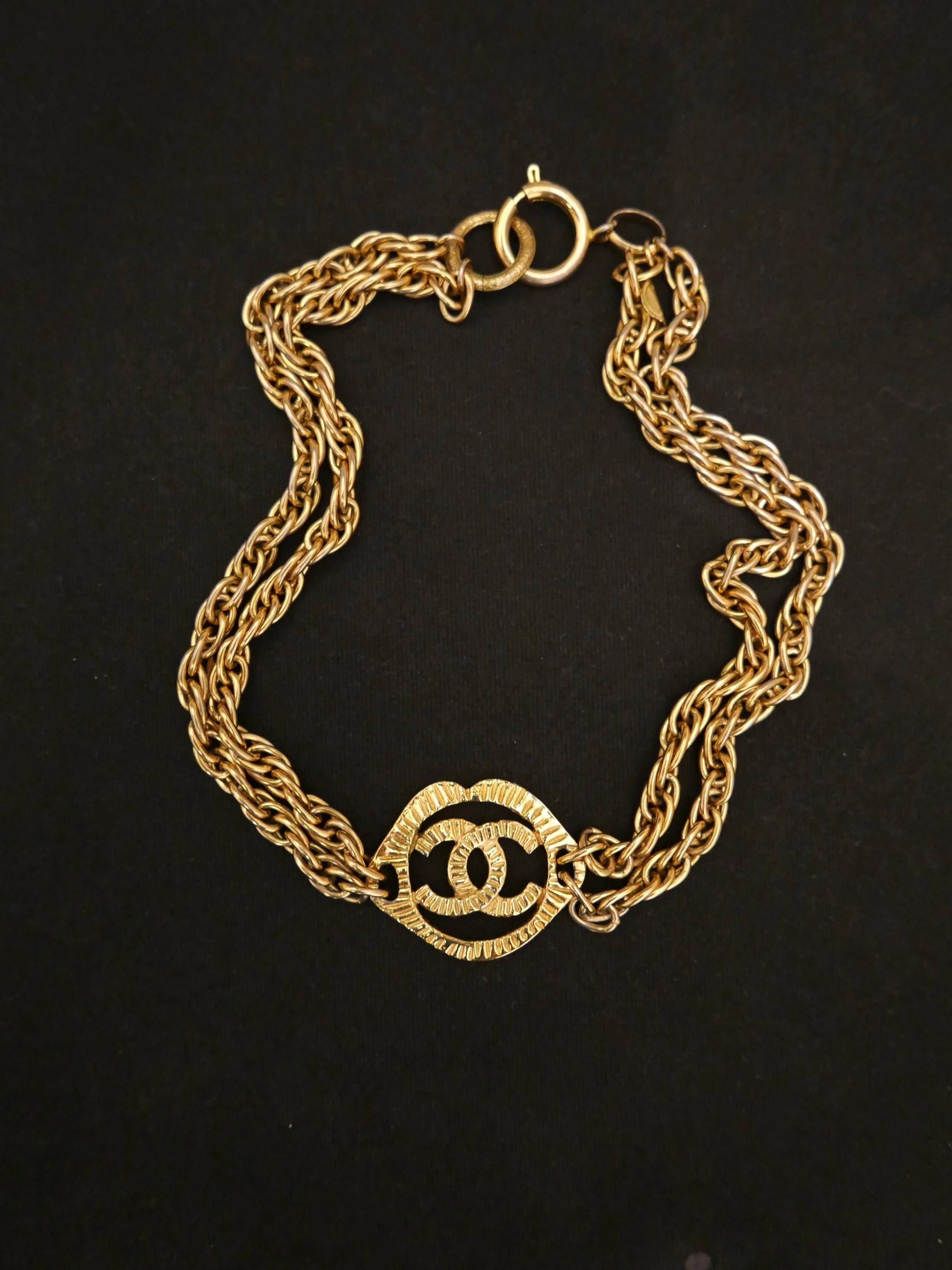 1970s Chanel gold toned necklace in double chain featuring a textured lip-shaped CC charm. Stamped CHANEL, made in France. Length 42cm (16.5 inches) Charm 3.2x4cm (1.25x1.57 inches) 

Condition: Signs of use consistent with age and normal use.