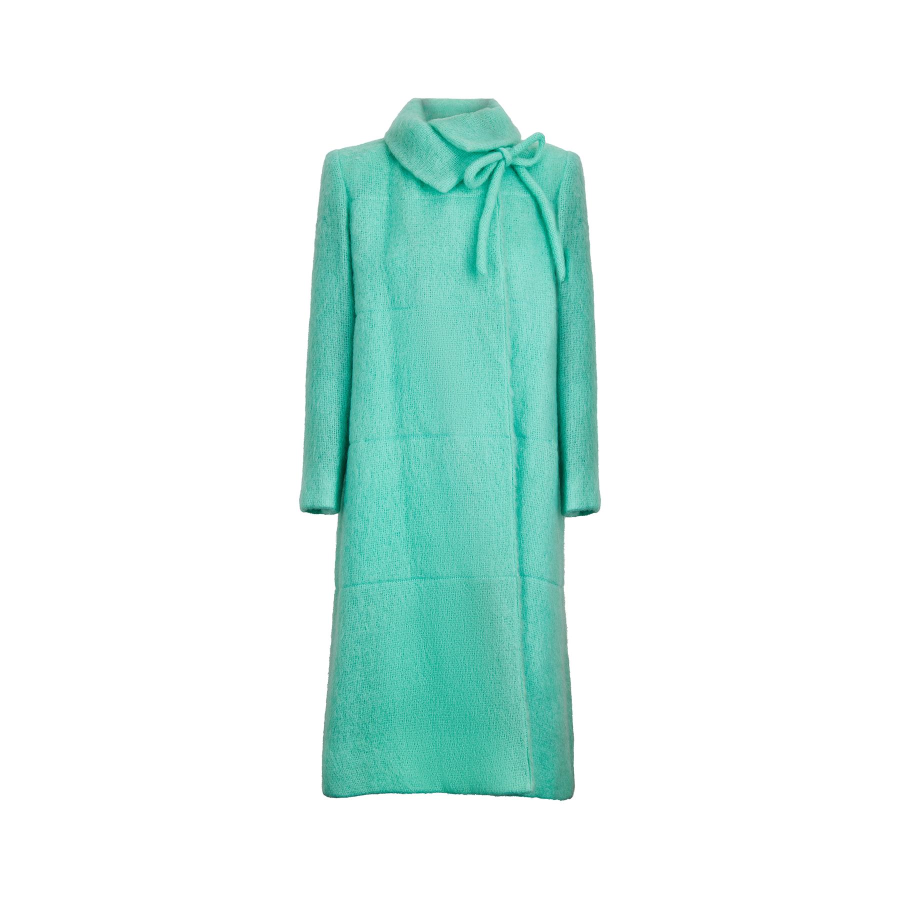 This early vintage Chanel Mohair coat is the most perfect shade of seafoam green and cut in an elegant and gently flared silhouette. It features a high collar with bow detail at the neck, and fastens with a single button closure on the collar line
