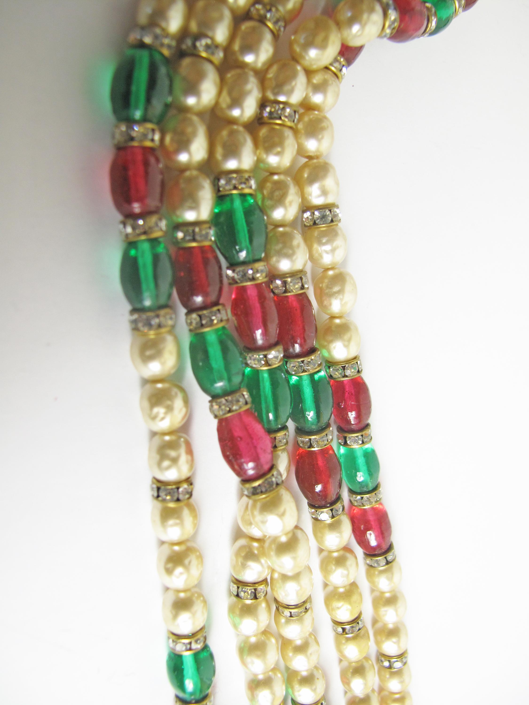 1970s Gold-tone Chanel multi-strand necklace featuring crystal accents, gripoix, faux pearls and hook closure. Chain Length 36“ . Condition: Very good, light scratches and tarnish at metal. 